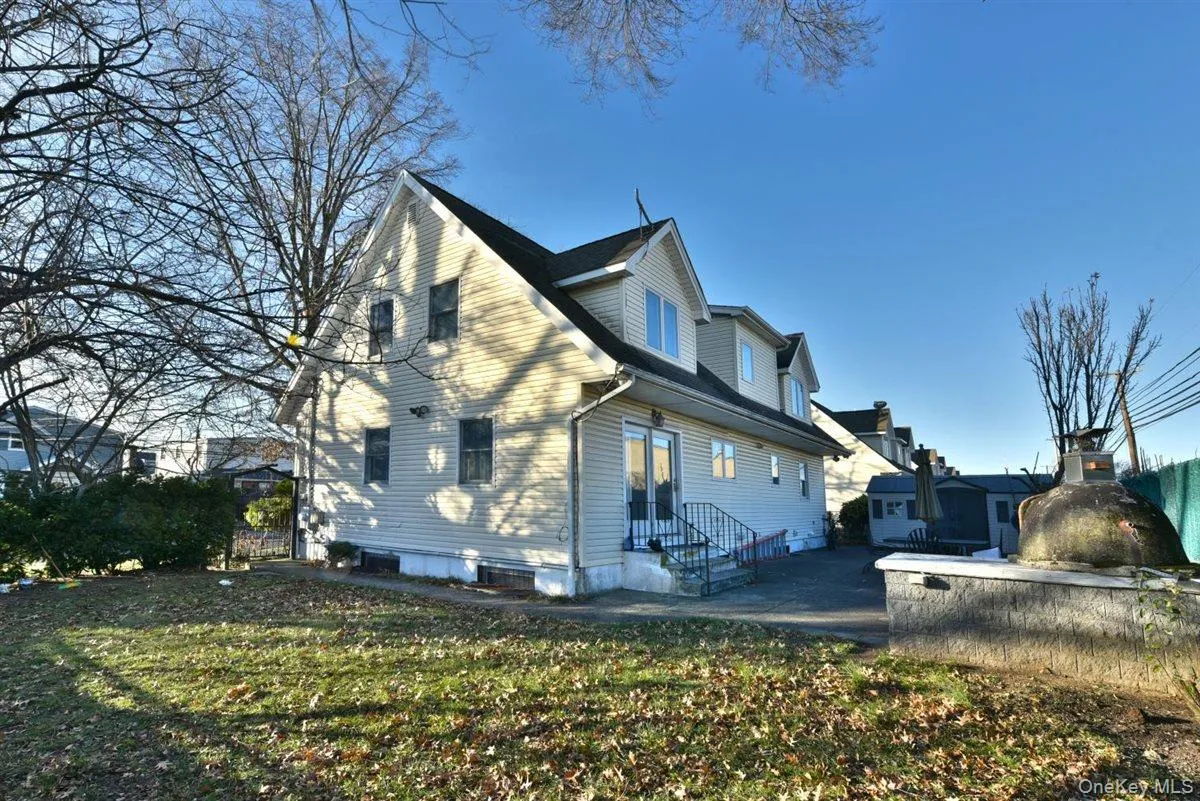 View of side of property featuring a yard View of side of property featuring a yard