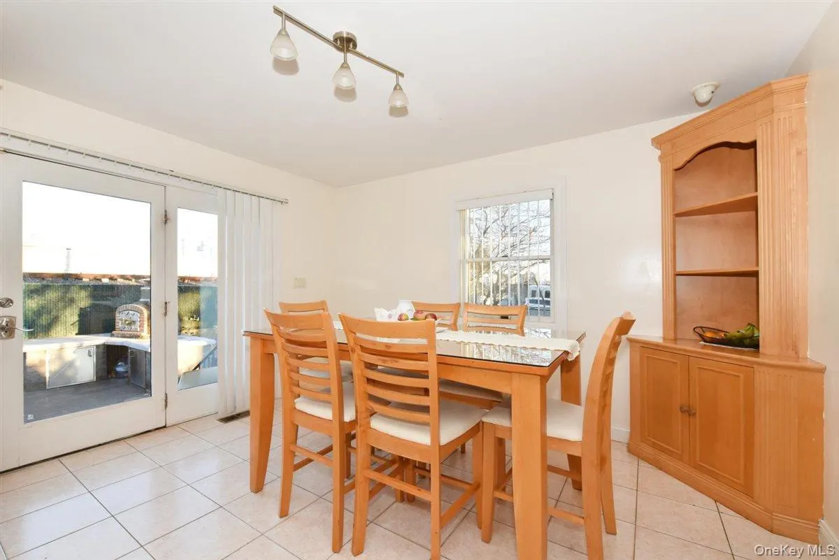 Dining space with plenty of natural light and light tile patterned flooring Dining space with plenty of natural light and light tile patterned flooring