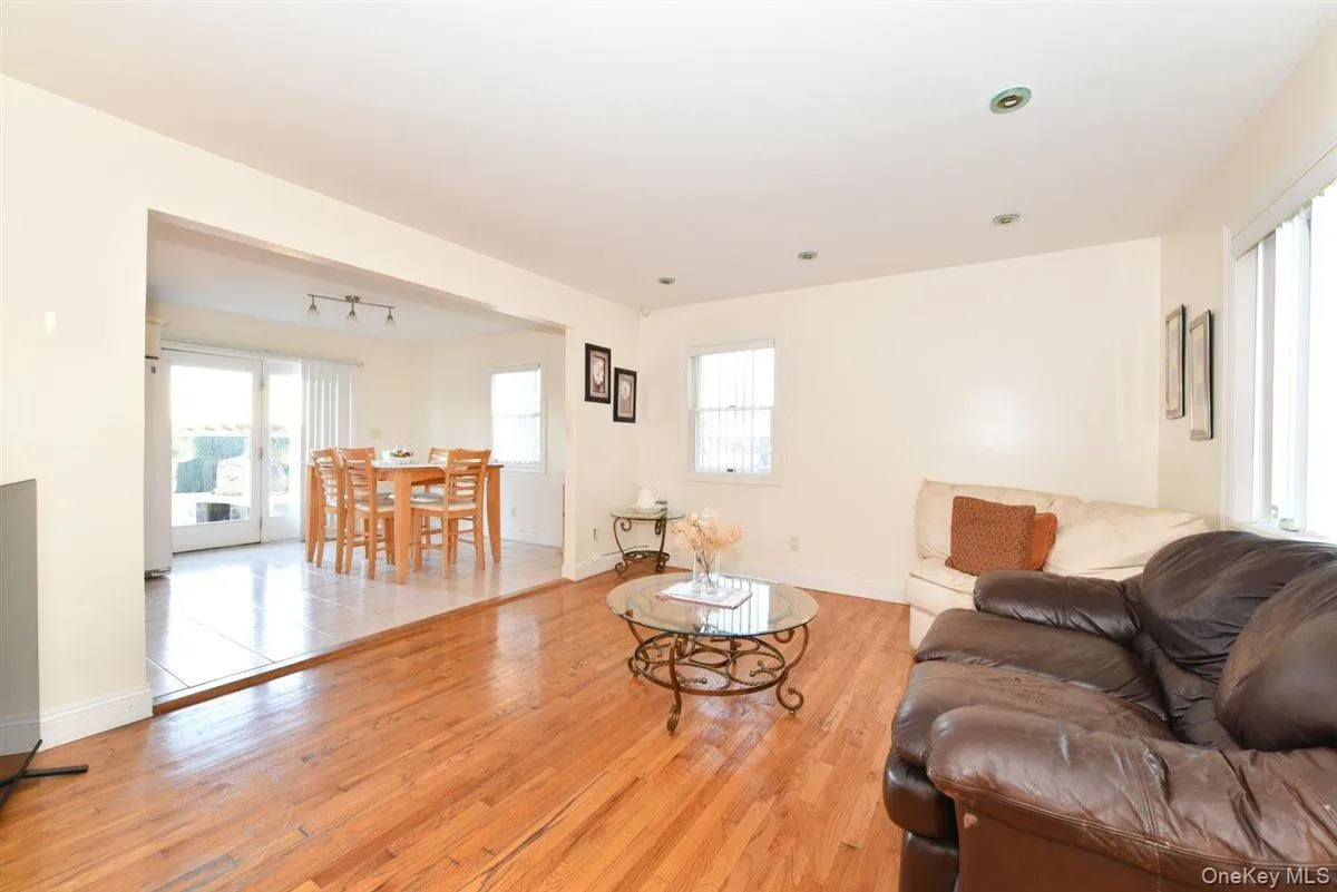 Living room featuring plenty of natural light and light wood-style floors Living room featuring plenty of natural light and light wood-style floors
