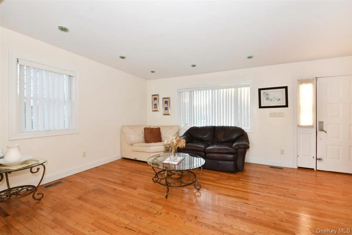 Living area featuring light wood-style flooring and healthy amount of natural light Living area featuring light wood-style flooring and healthy amount of natural light