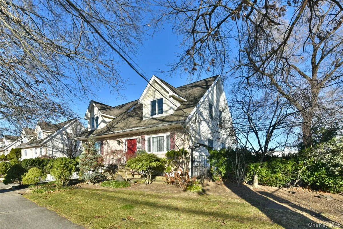 Cape cod-style house featuring a front lawn Cape cod-style house featuring a front lawn