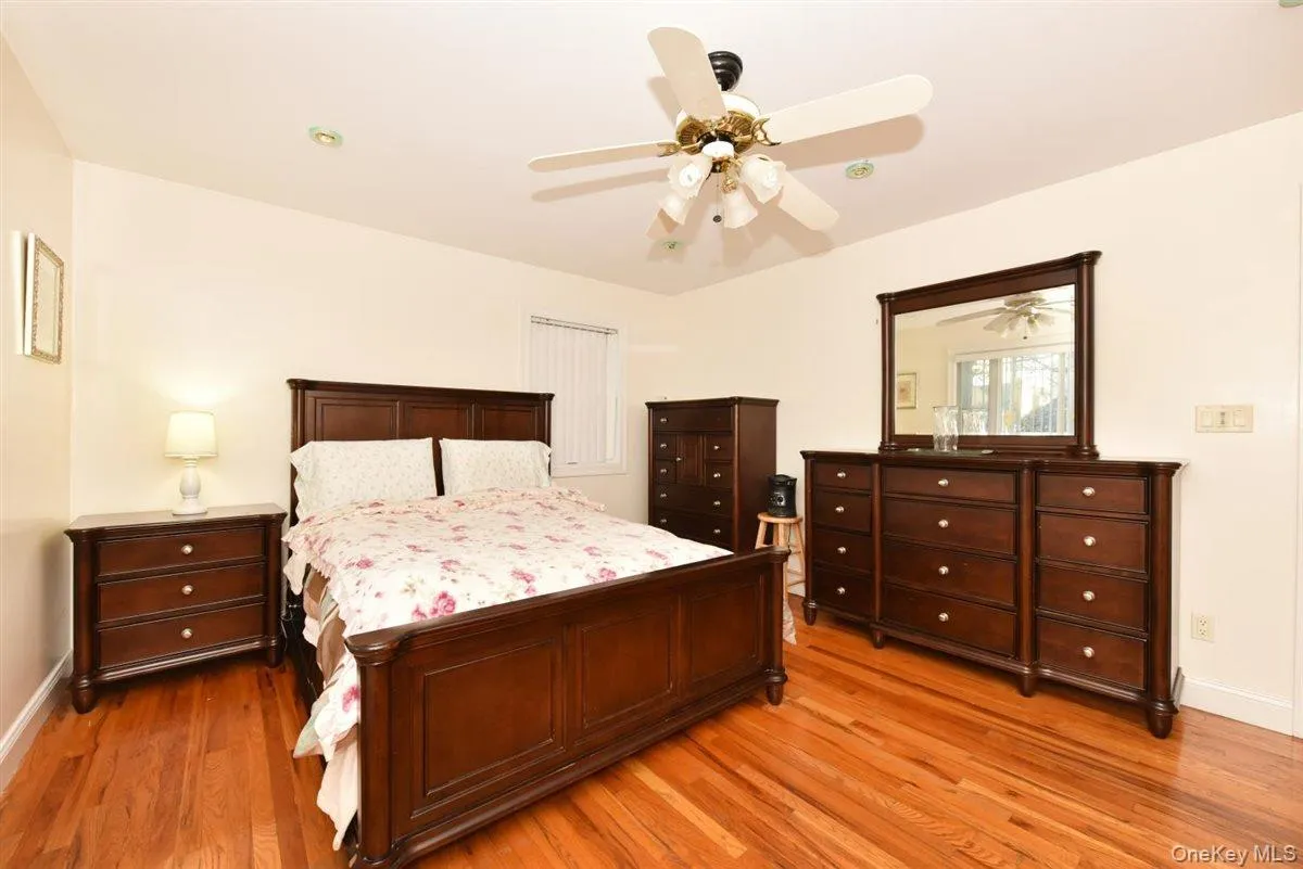 Bedroom with ceiling fan and light wood finished floors Bedroom with ceiling fan and light wood finished floors