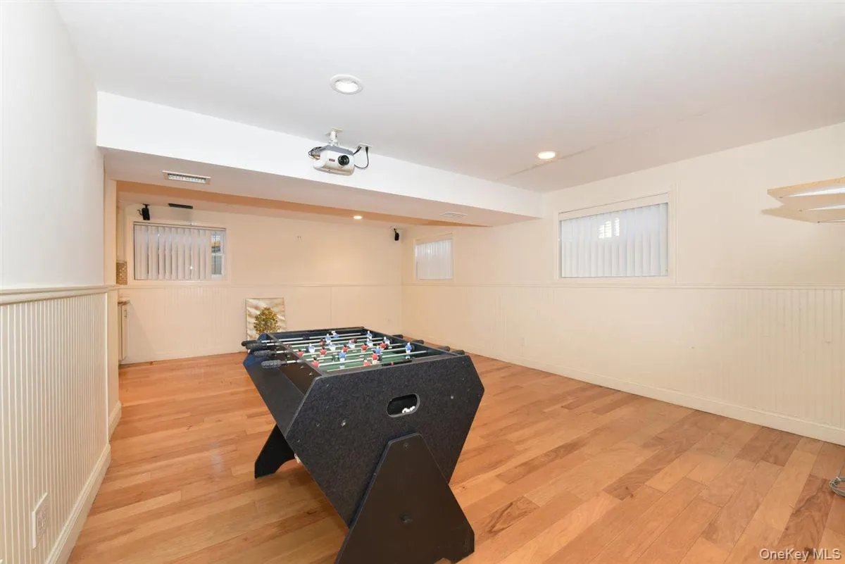 Playroom with wainscoting and light wood finished floors Playroom with wainscoting and light wood finished floors