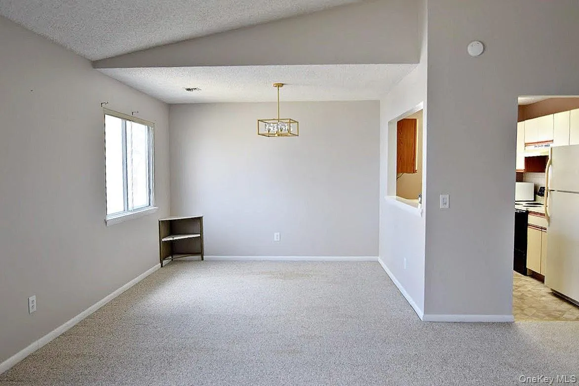 Directly across from the kitchen, light-filled Directly across from the kitchen, light-filled