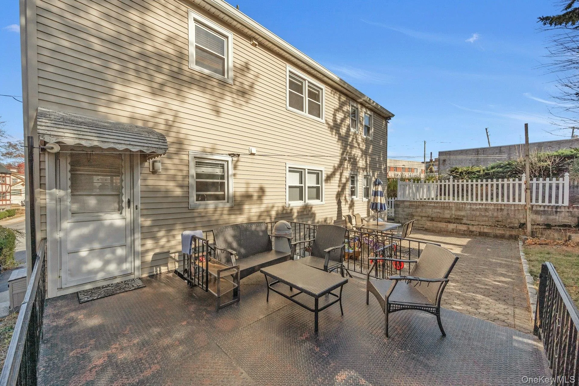 Rear view of house featuring a patio area and an outdoor hangout area Rear view of house featuring a patio area and an outdoor hangout area