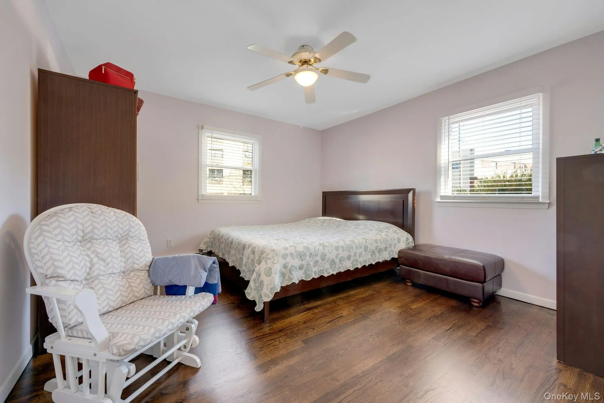 Bedroom featuring ceiling fan and dark hardwood / wood-style flooring Bedroom featuring ceiling fan and dark hardwood / wood-style flooring