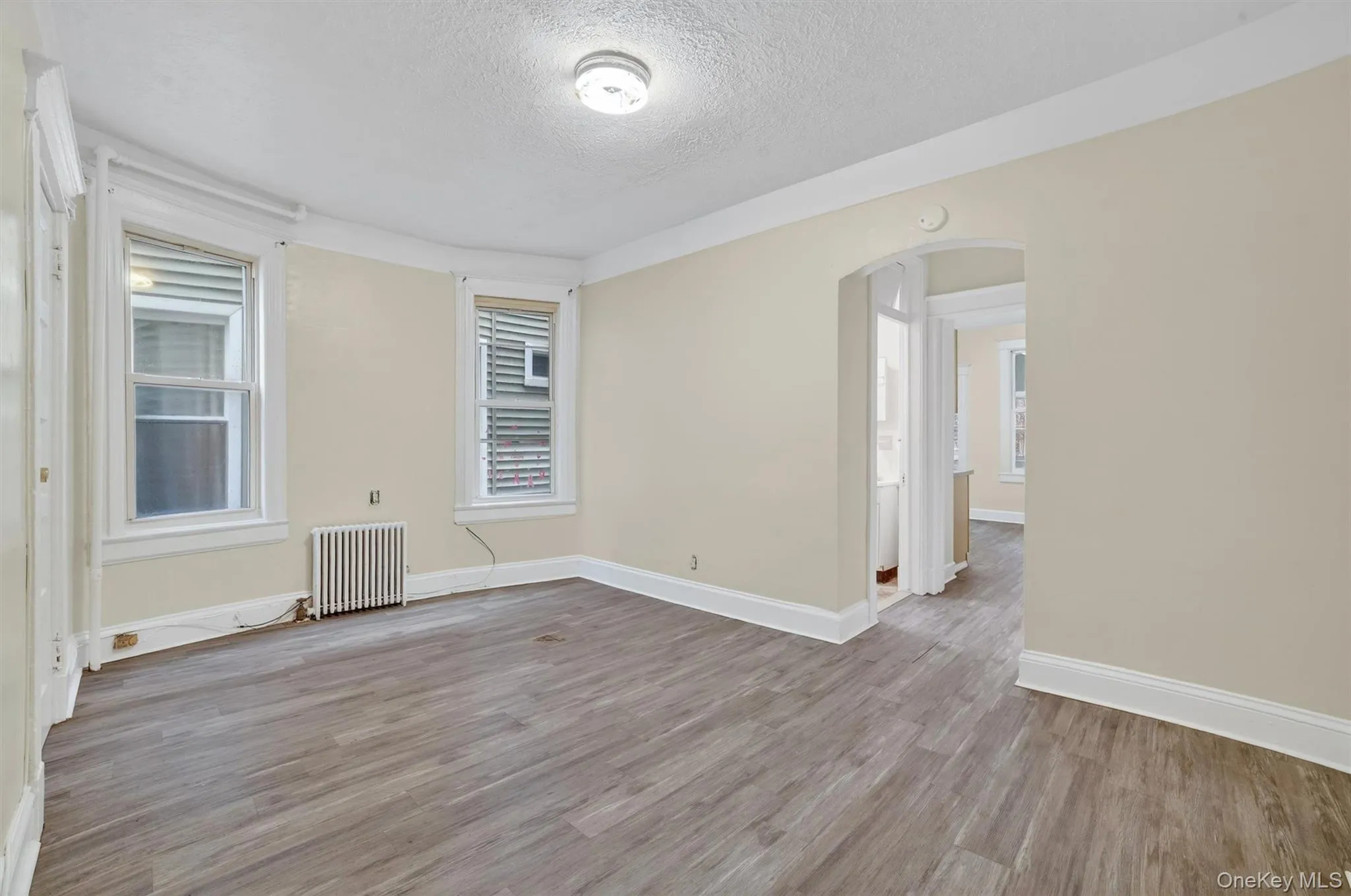 View of Living Room from Apartment Entrance with kitchen beyond View of Living Room from Apartment Entrance with kitchen beyond