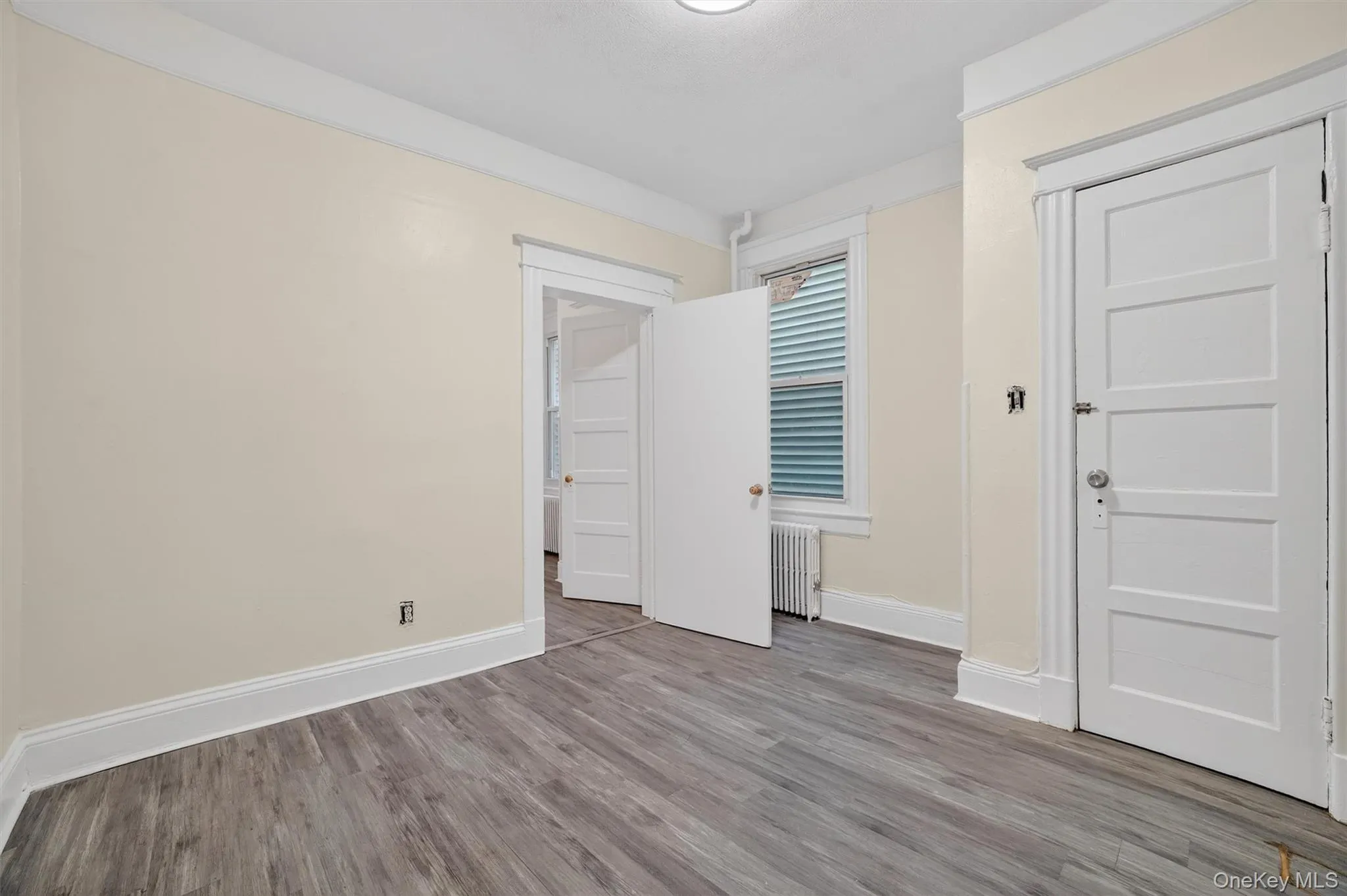 Bedroom 1 with Closet Door Shut and Entrance to Bedroom 2 shown Bedroom 1 with Closet Door Shut and Entrance to Bedroom 2 shown