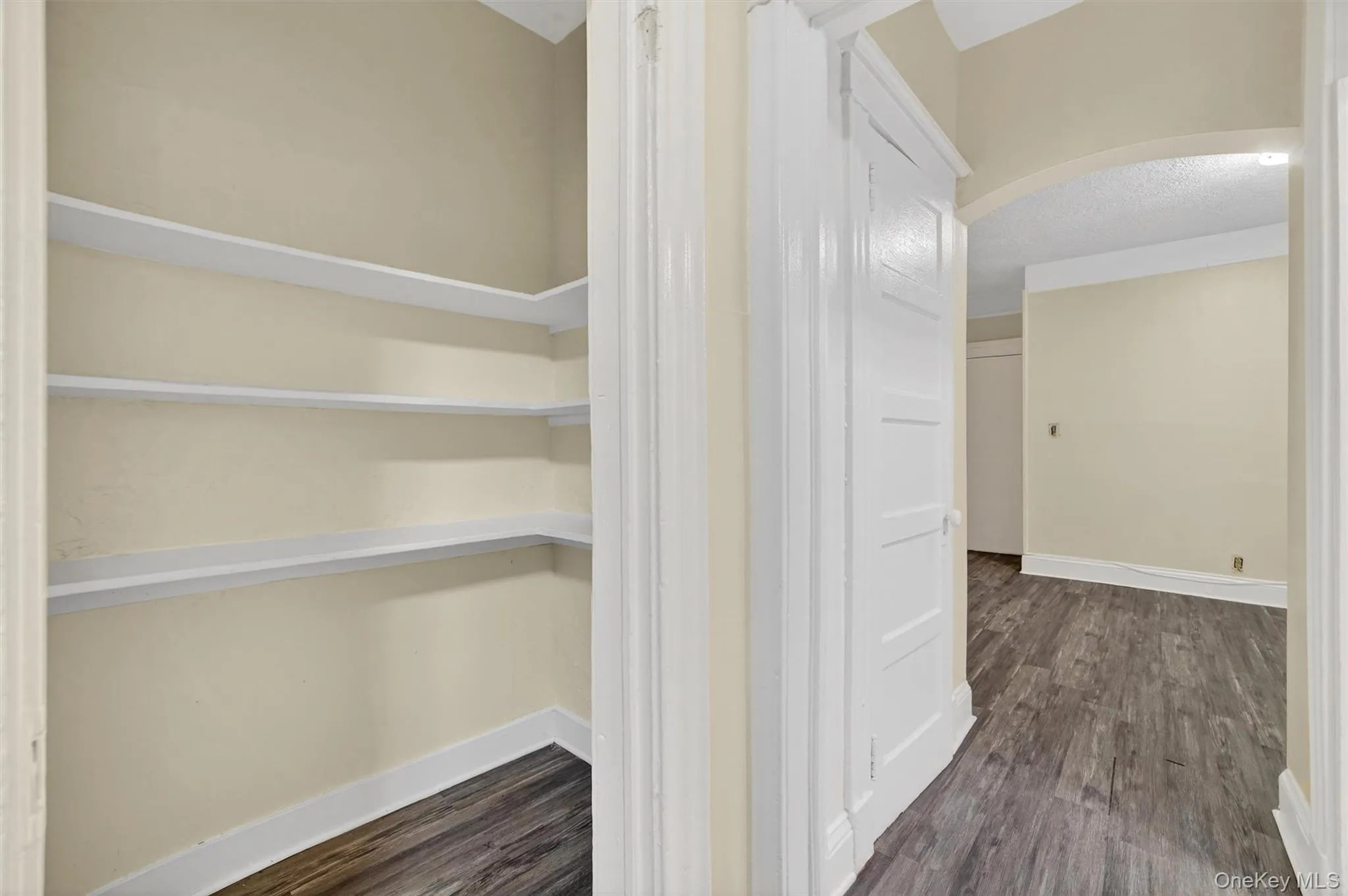 Pantry to left looking into hallway with bathroom on right and living room beyond Pantry to left looking into hallway with bathroom on right and living room beyond