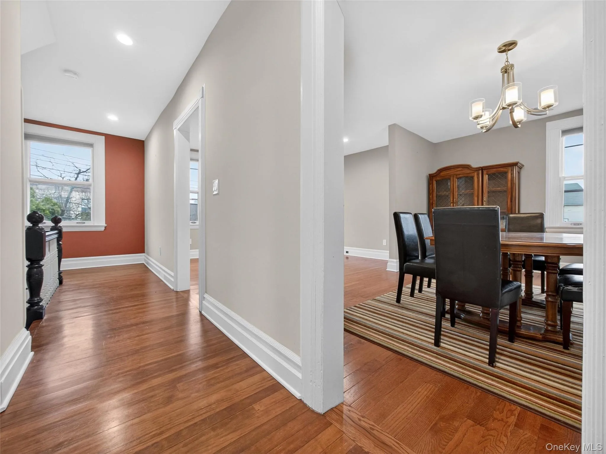 Dining room featuring dark wood-style floors and hanging lights Dining room featuring dark wood-style floors and hanging lights