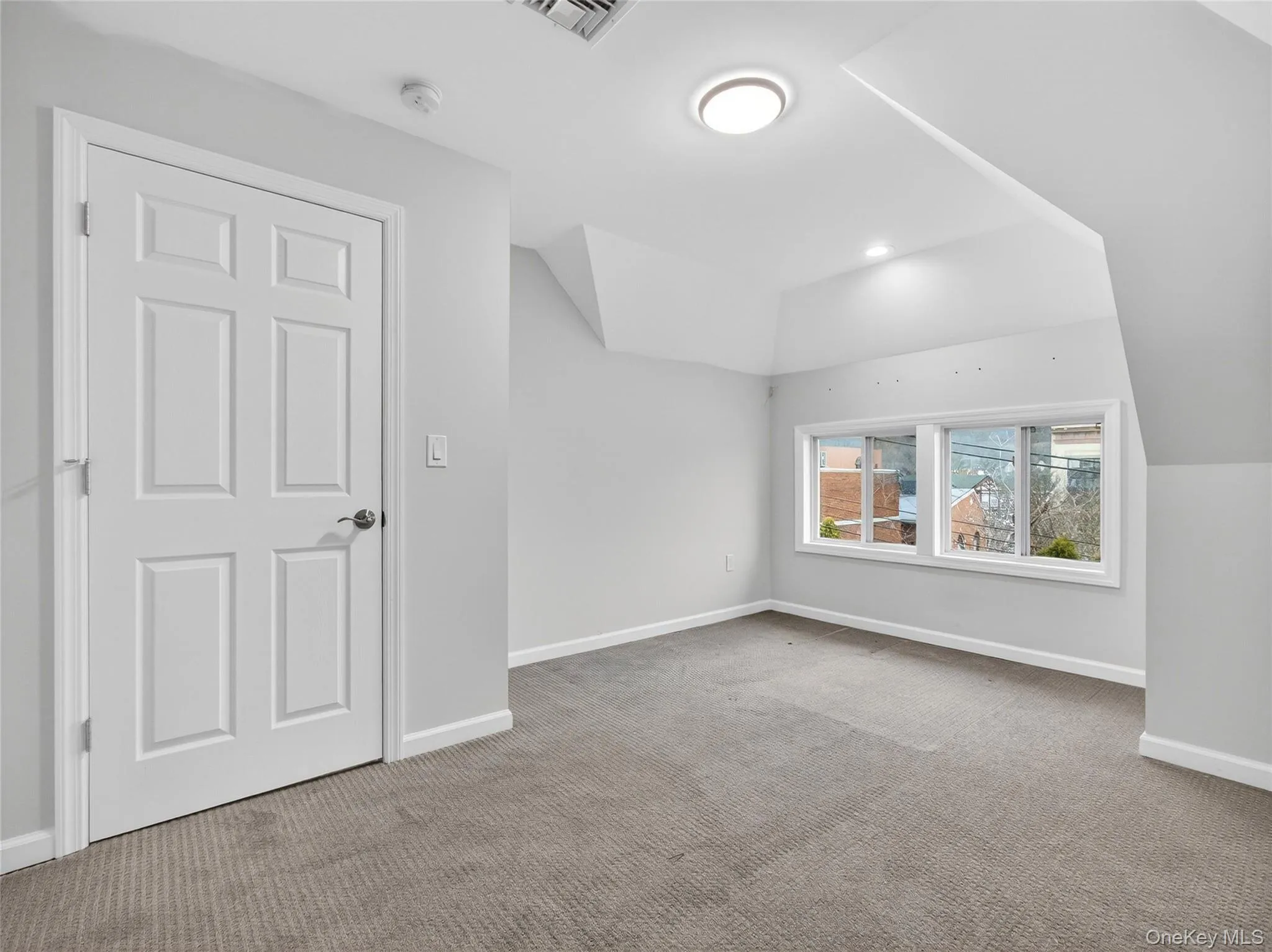 Additional living space with lofted ceiling and light colored carpet Additional living space with lofted ceiling and light colored carpet