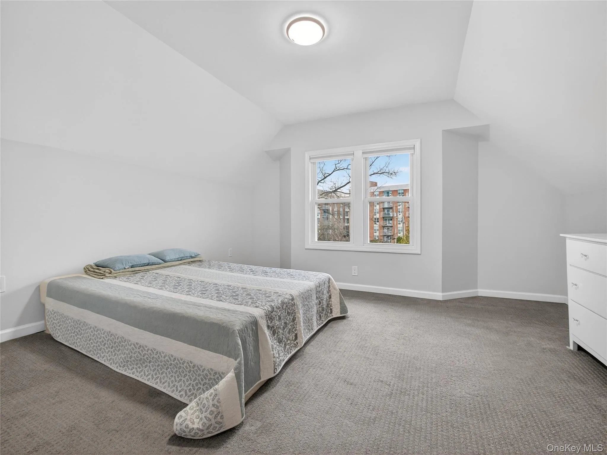 Carpeted bedroom with vaulted ceiling Carpeted bedroom with vaulted ceiling