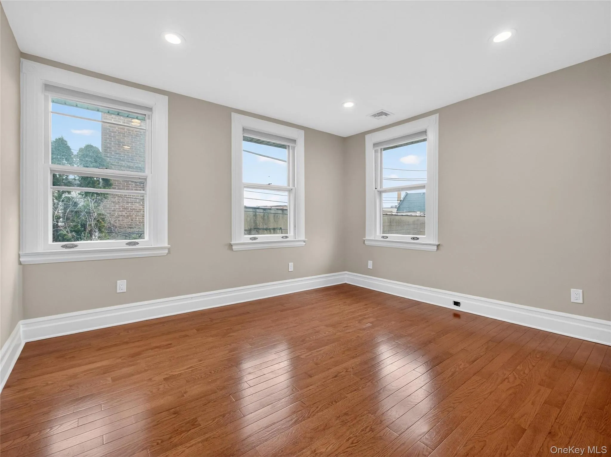 Spare room with dark wood-type flooring and recessed lighting Spare room with dark wood-type flooring and recessed lighting