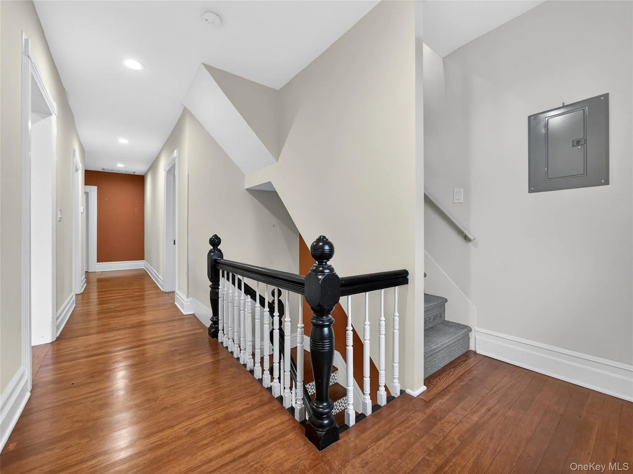Stairway with electric panel, wood-type flooring, and recessed lighting Stairway with electric panel, wood-type flooring, and recessed lighting
