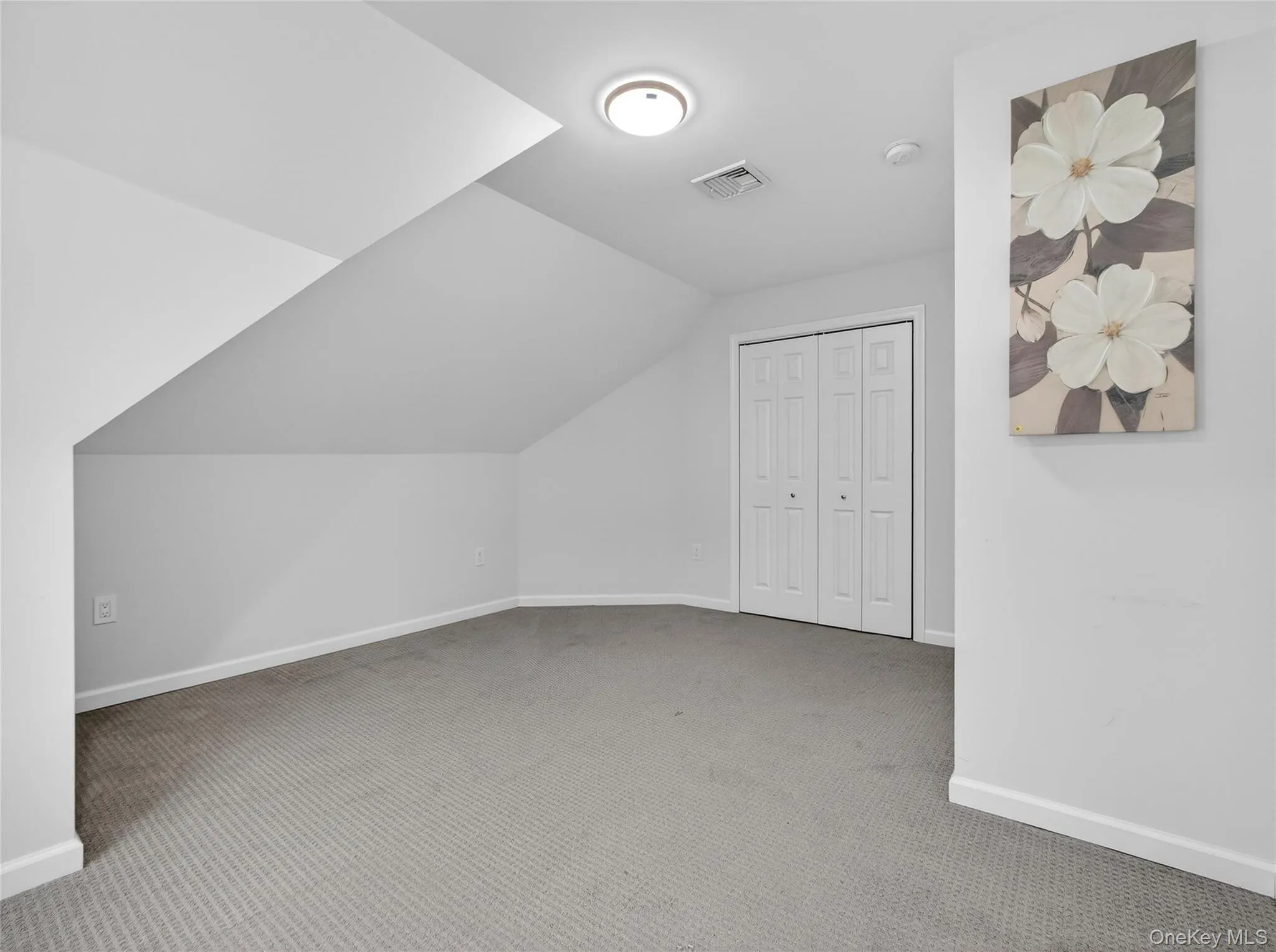 Additional living space featuring light colored carpet and lofted ceiling Additional living space featuring light colored carpet and lofted ceiling