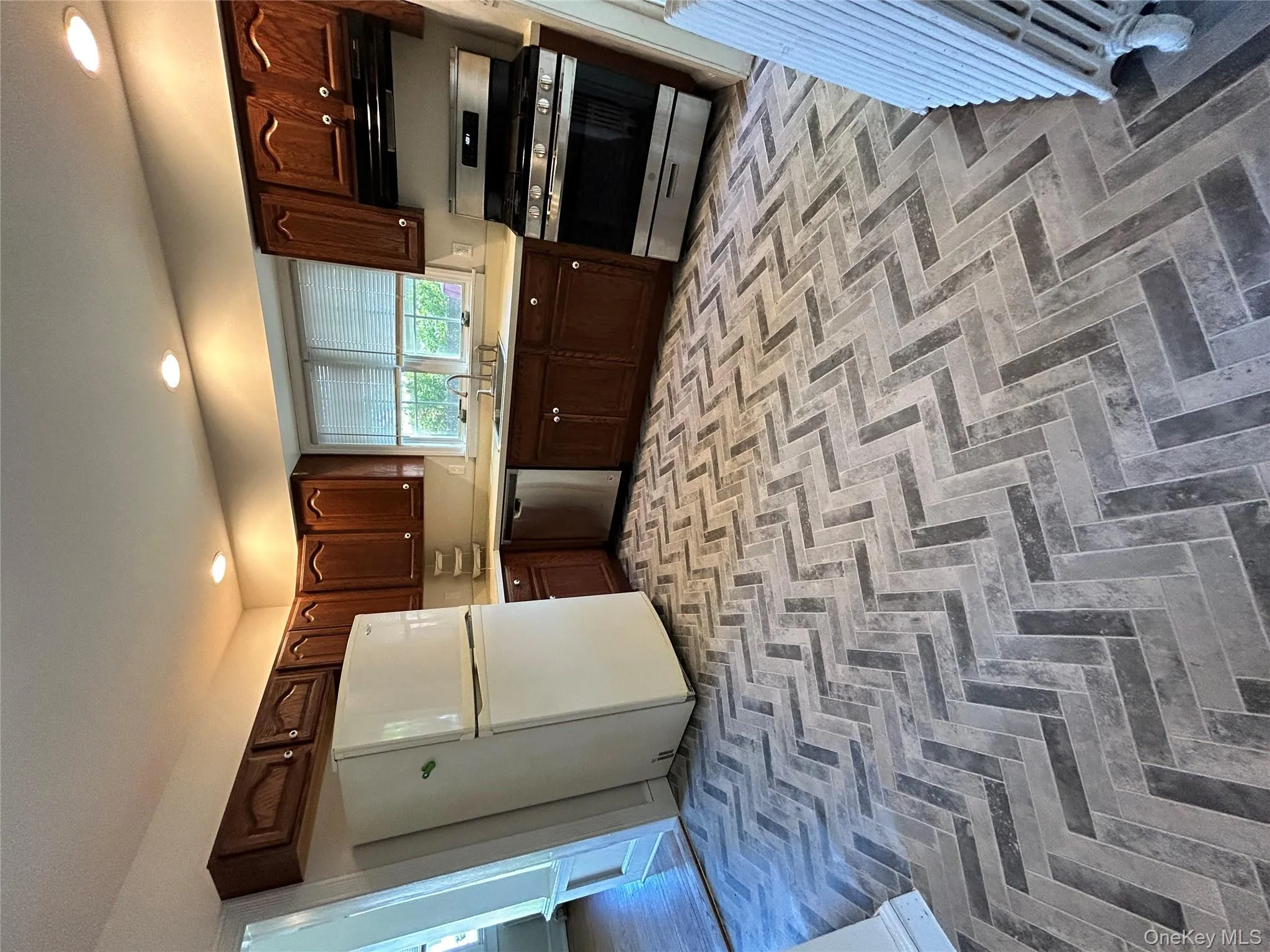 Kitchen featuring stove, refrigerator, dark brown cabinets, a sink, and dishwasher Kitchen featuring stove, refrigerator, dark brown cabinets, a sink, and dishwasher