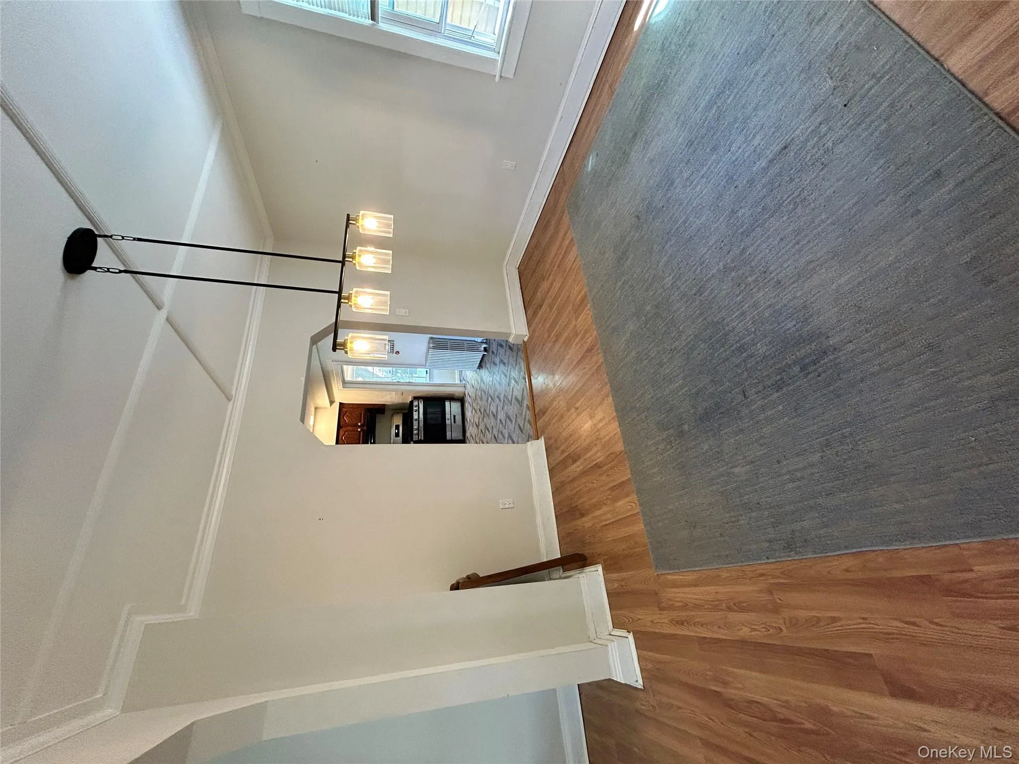 Unfurnished dining area with baseboards, arched walkways, crown molding, and wood finished floors Unfurnished dining area with baseboards, arched walkways, crown molding, and wood finished floors