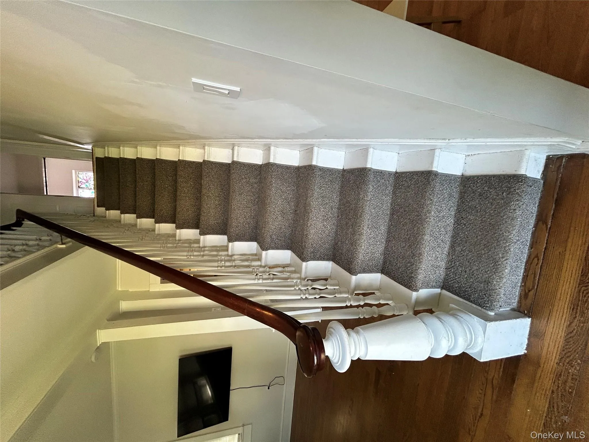 Staircase featuring baseboards and wood finished floors Staircase featuring baseboards and wood finished floors