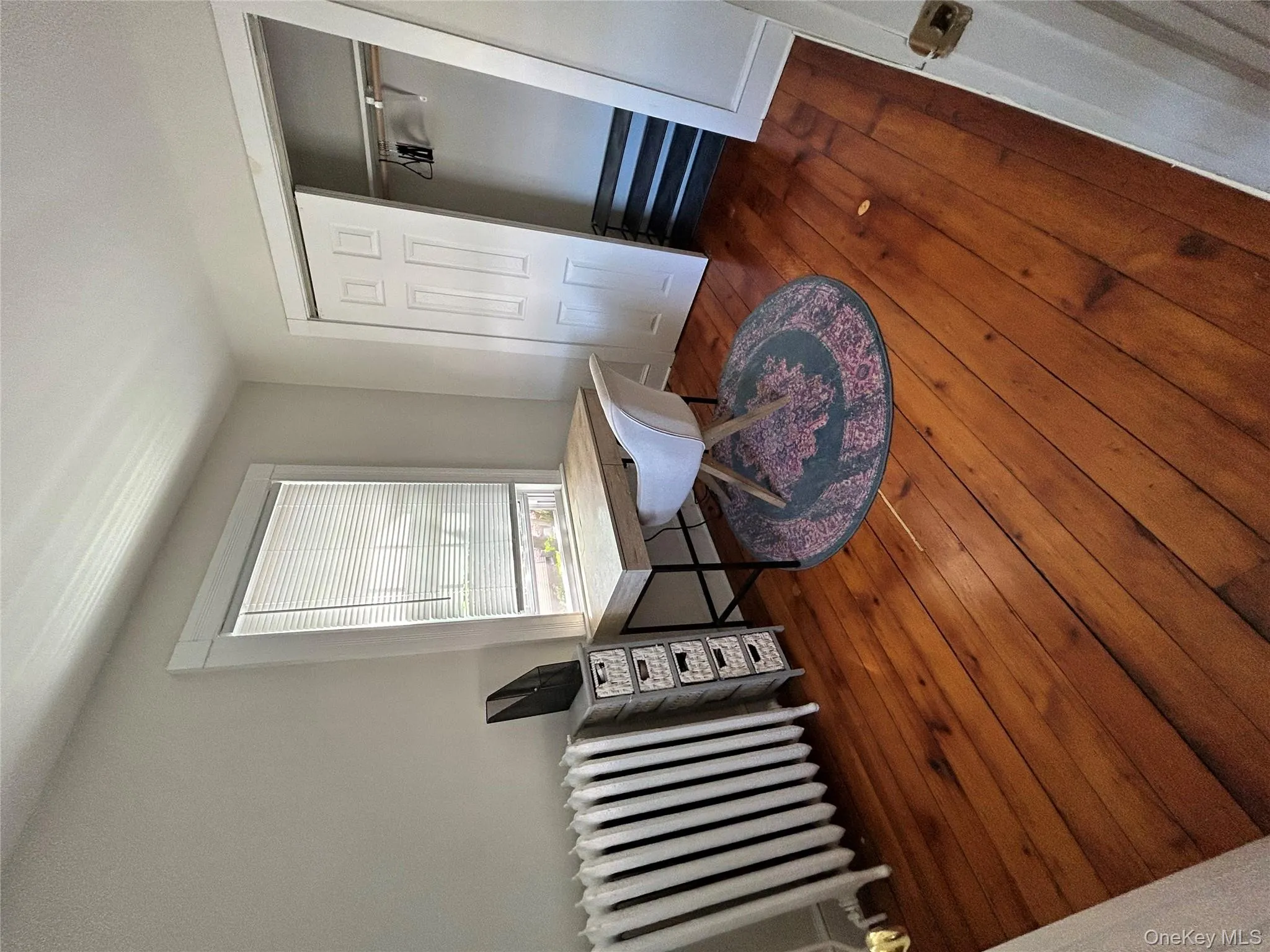 Office space with radiator heating unit and hardwood / wood-style floors Office space with radiator heating unit and hardwood / wood-style floors