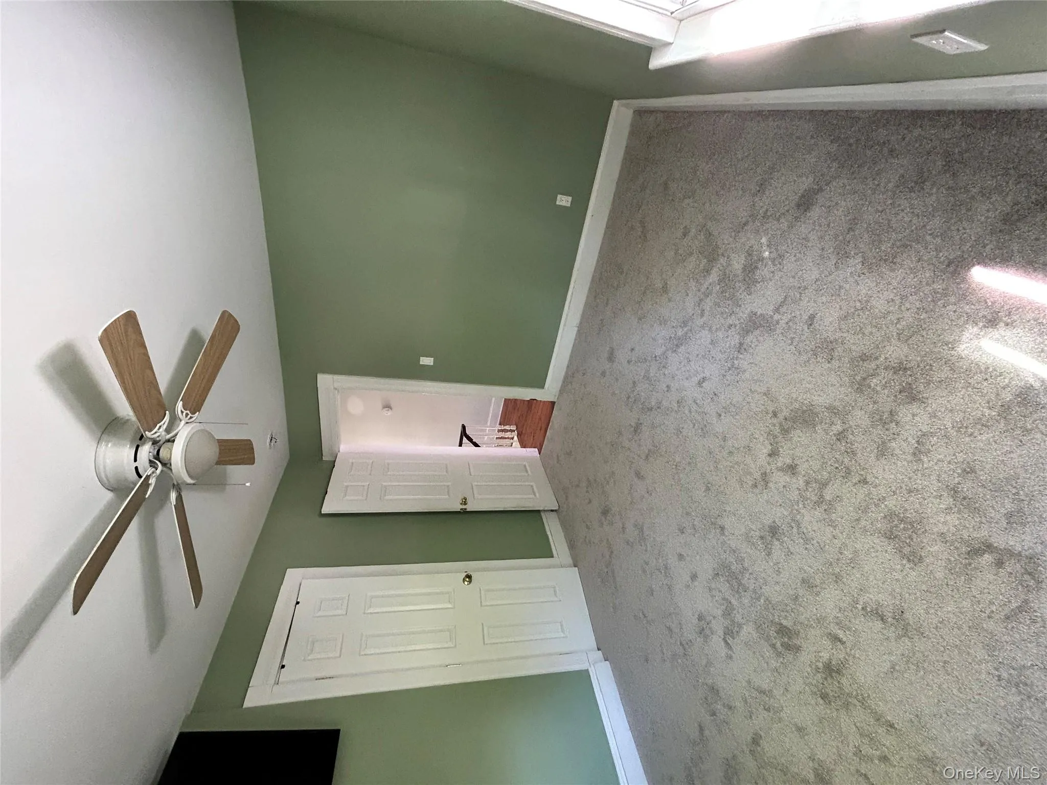 Unfurnished bedroom featuring baseboards, carpet, and a ceiling fan Unfurnished bedroom featuring baseboards, carpet, and a ceiling fan