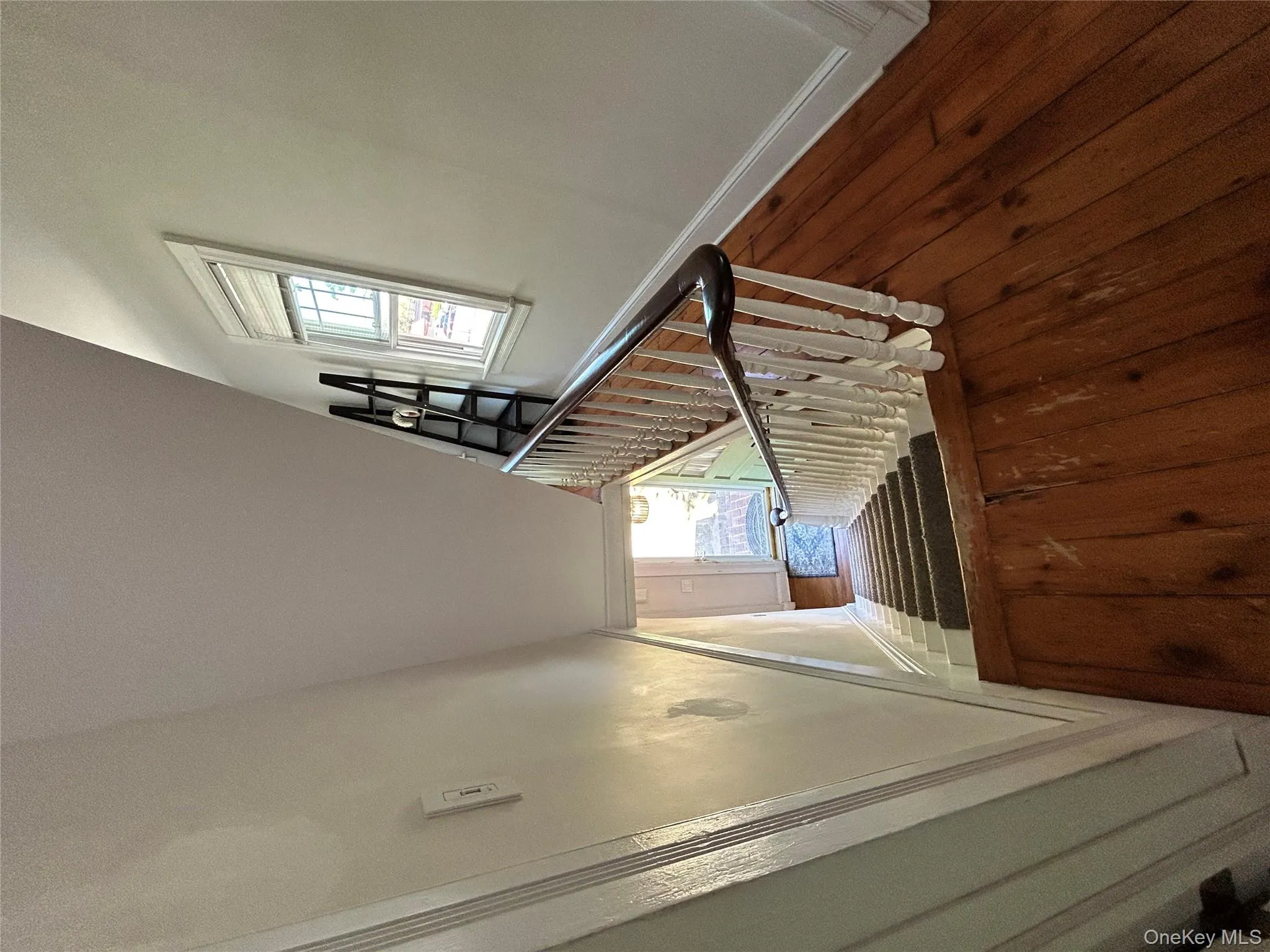 Stairs featuring wood-type flooring and baseboards Stairs featuring wood-type flooring and baseboards