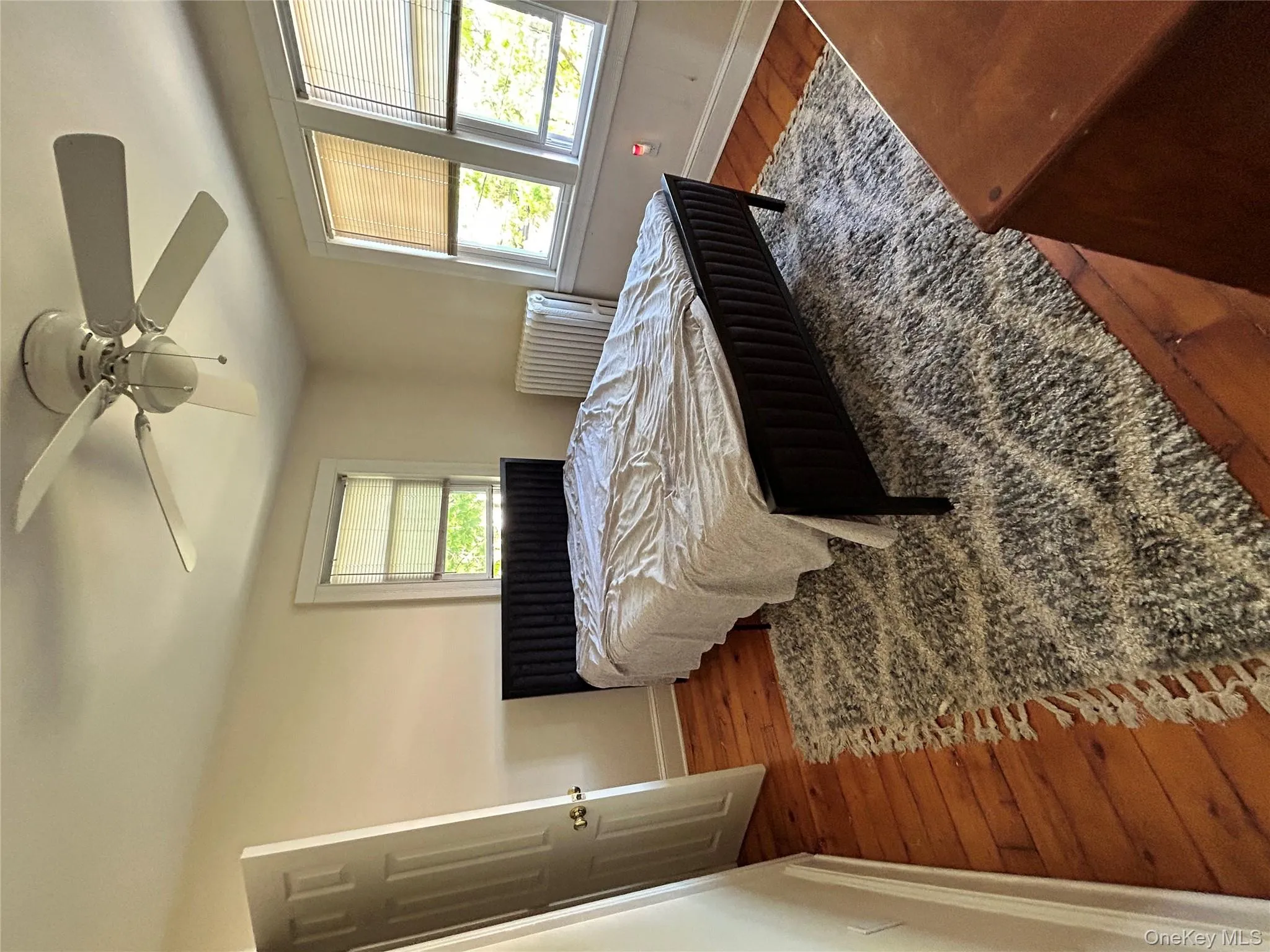 Bedroom featuring baseboards, a ceiling fan, and wood finished floors Bedroom featuring baseboards, a ceiling fan, and wood finished floors