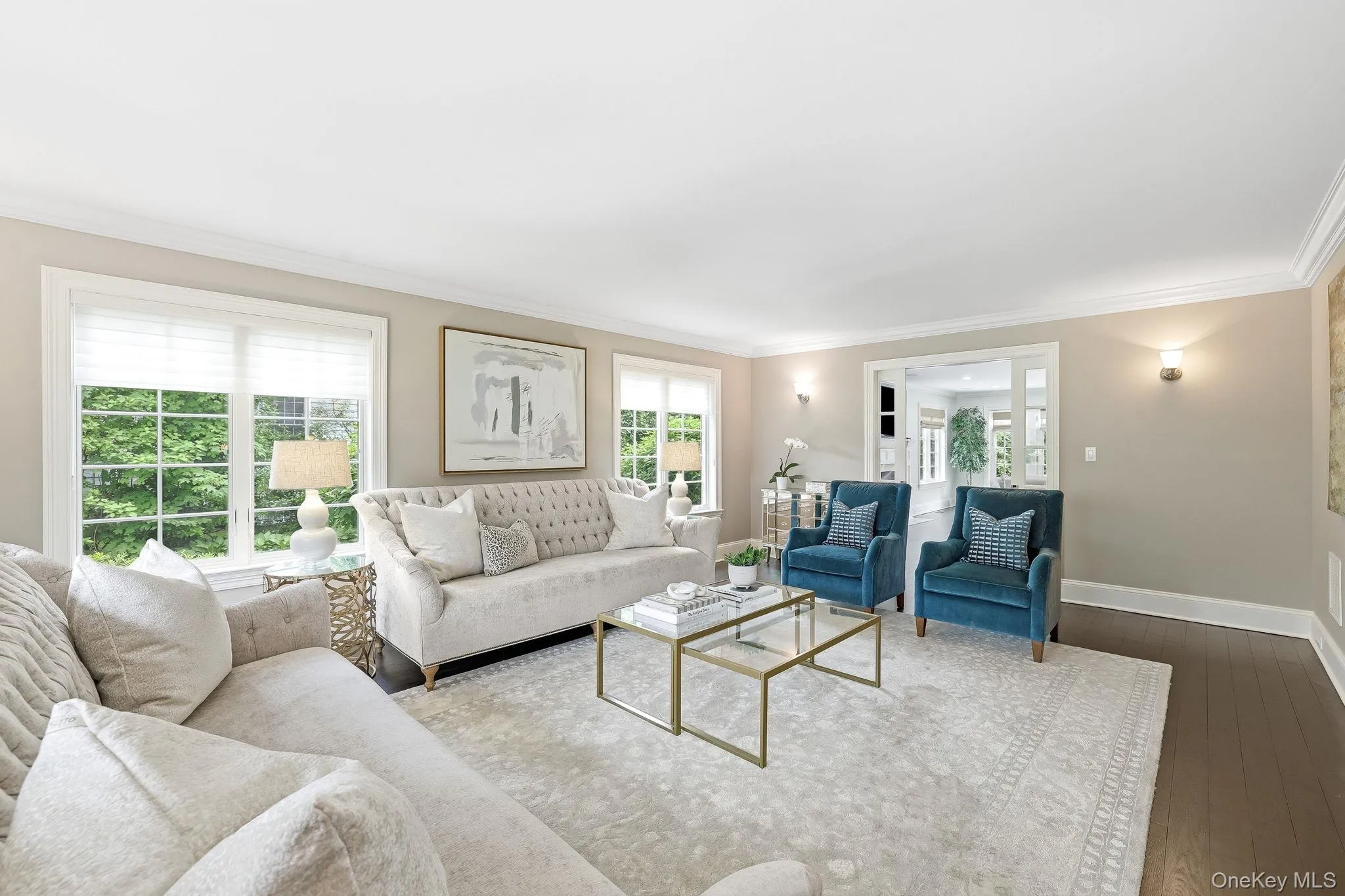 Sophisticated formal living room featuring sliding glass doors to the family room, ideal for hosting family and friends. Sophisticated formal living room featuring sliding glass doors to the family room, ideal for hosting family and friends.