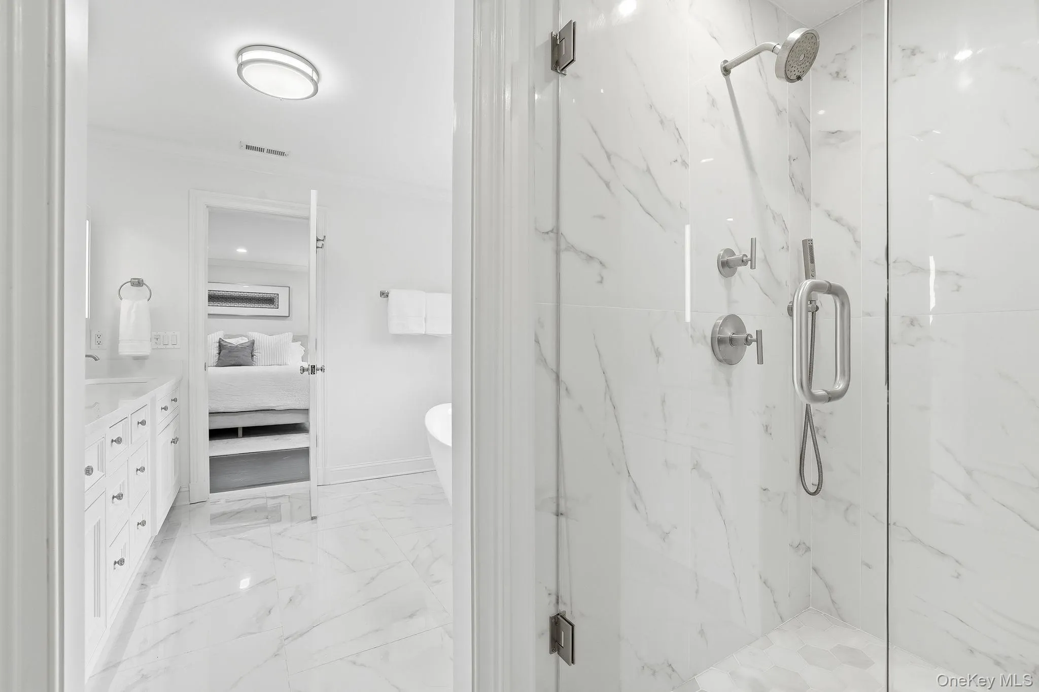 Ensuite primary bathroom with heated floors, double vanity, oversized shower and separate bath. Ensuite primary bathroom with heated floors, double vanity, oversized shower and separate bath.
