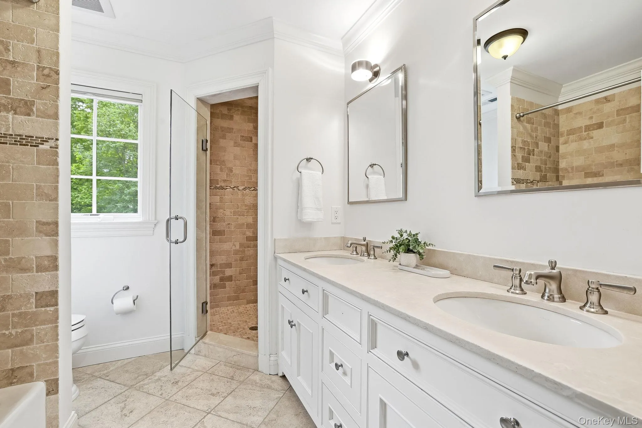Hall bathroom with double vanity, shower and separate tub serves two of the second floor bedrooms. Hall bathroom with double vanity, shower and separate tub serves two of the second floor bedrooms.