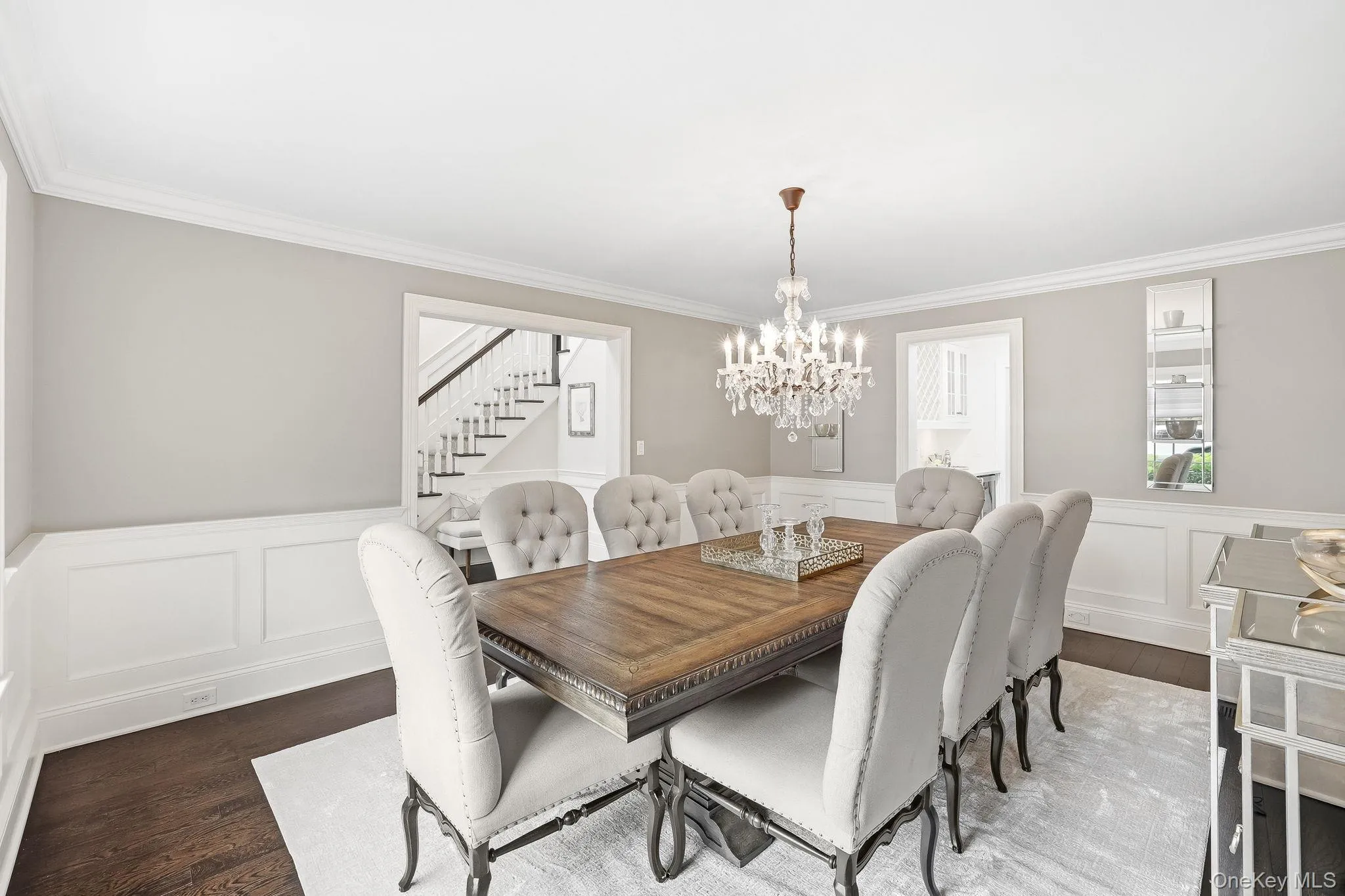 Elegant dining room featuring wainscoting and flowing to the butler's pantry for easy entertaining. Elegant dining room featuring wainscoting and flowing to the butler's pantry for easy entertaining.