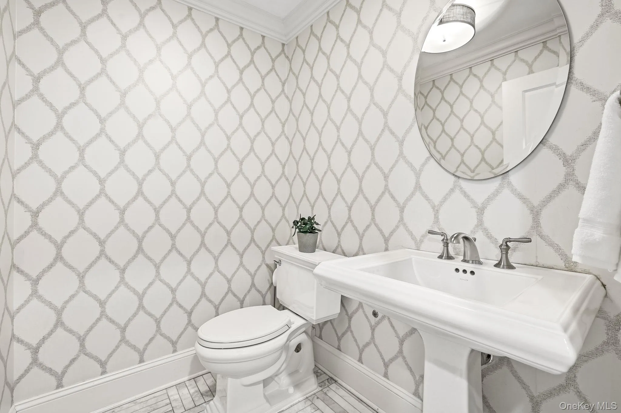 Luxurious first level powder room with marble flooring. Luxurious first level powder room with marble flooring.
