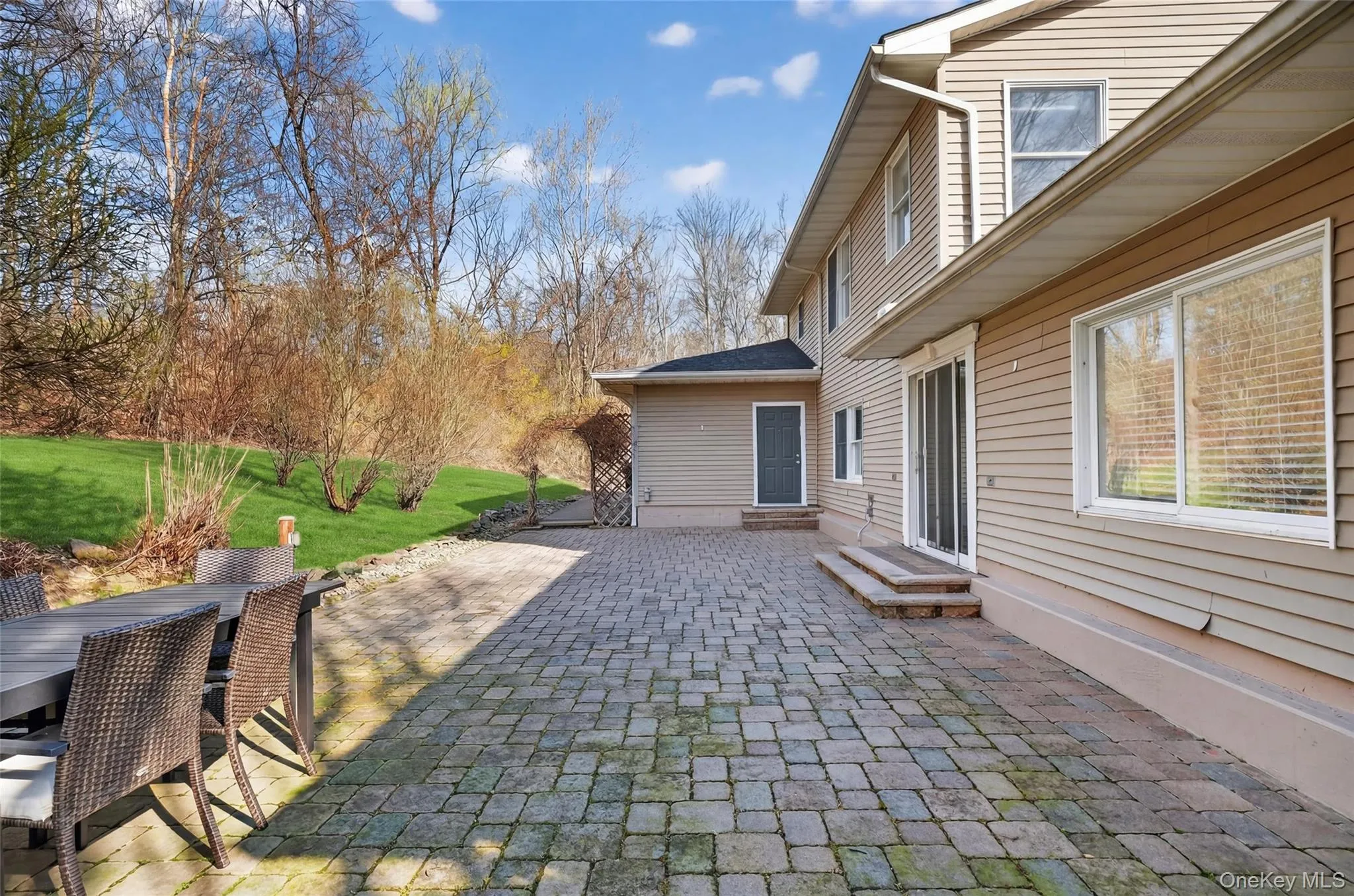 View of patio / terrace featuring outdoor dining area and entry steps View of patio / terrace featuring outdoor dining area and entry steps