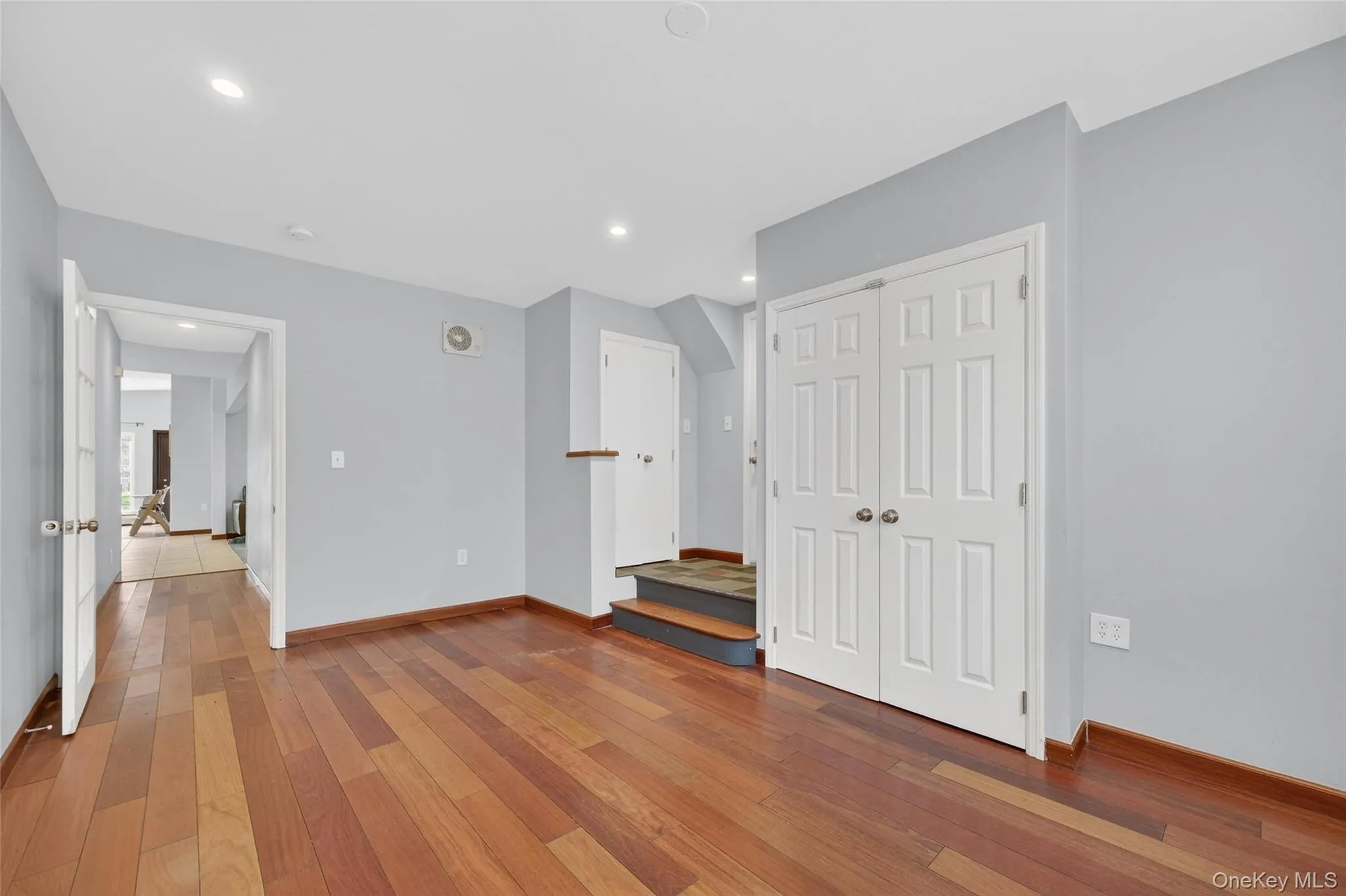 Unfurnished room with light wood-style flooring, a closet, and recessed lighting Unfurnished room with light wood-style flooring, a closet, and recessed lighting
