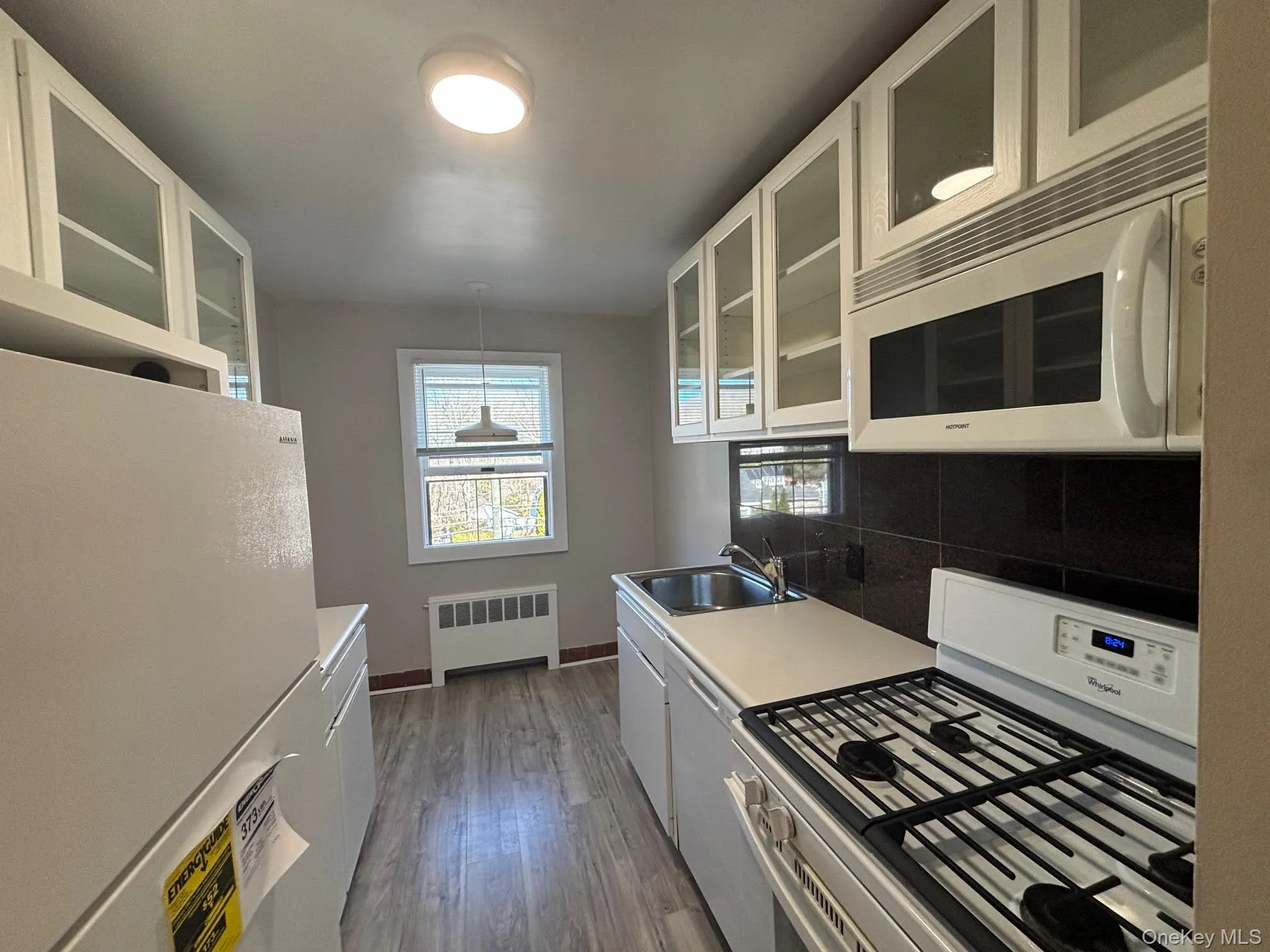 Updated kitchen with new refrigerator and small breakfast nook. Updated kitchen with new refrigerator and small breakfast nook.