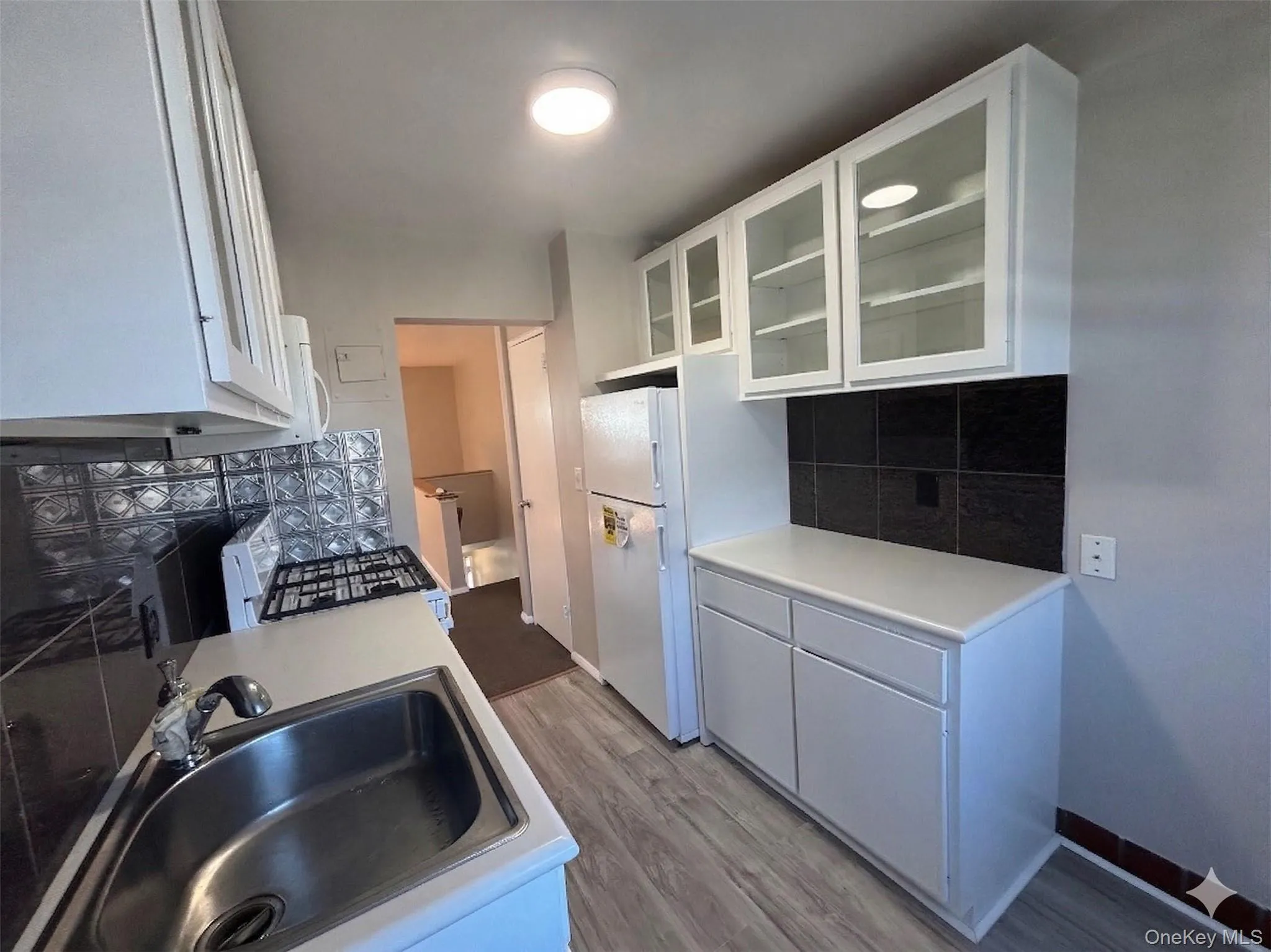 Updated kitchen with new refrigerator and small breakfast nook. Updated kitchen with new refrigerator and small breakfast nook.