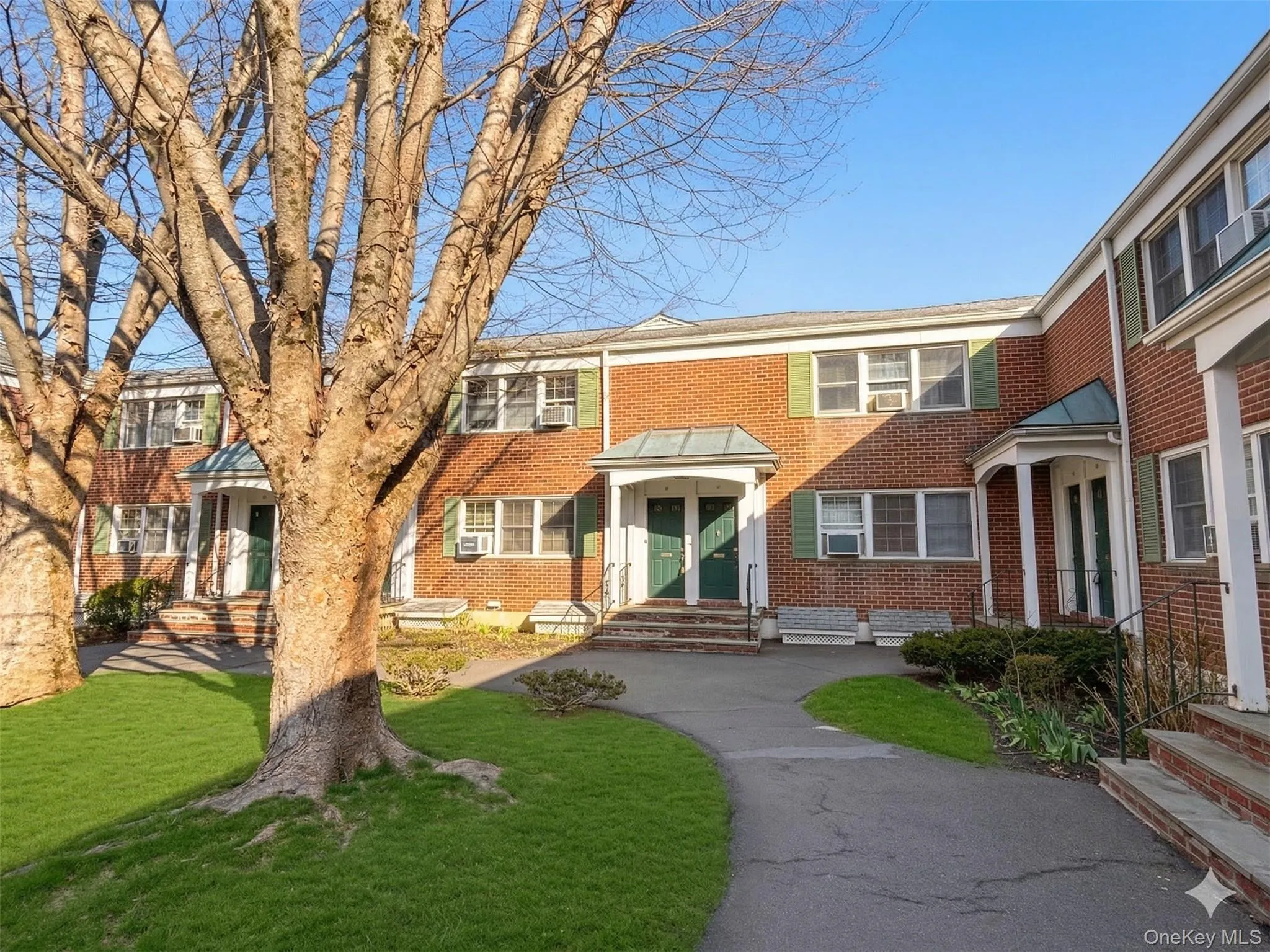 View of unit main entrance overlooking peaceful park-like courtyard. View of unit main entrance overlooking peaceful park-like courtyard.