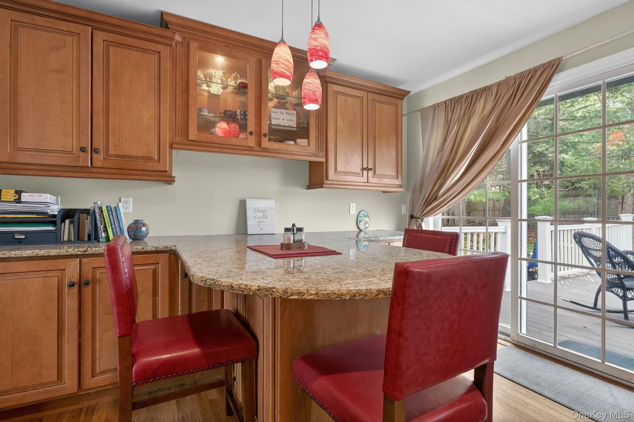 Kitchen peninsula with sliding doors to deck and backyard. Kitchen peninsula with sliding doors to deck and backyard.