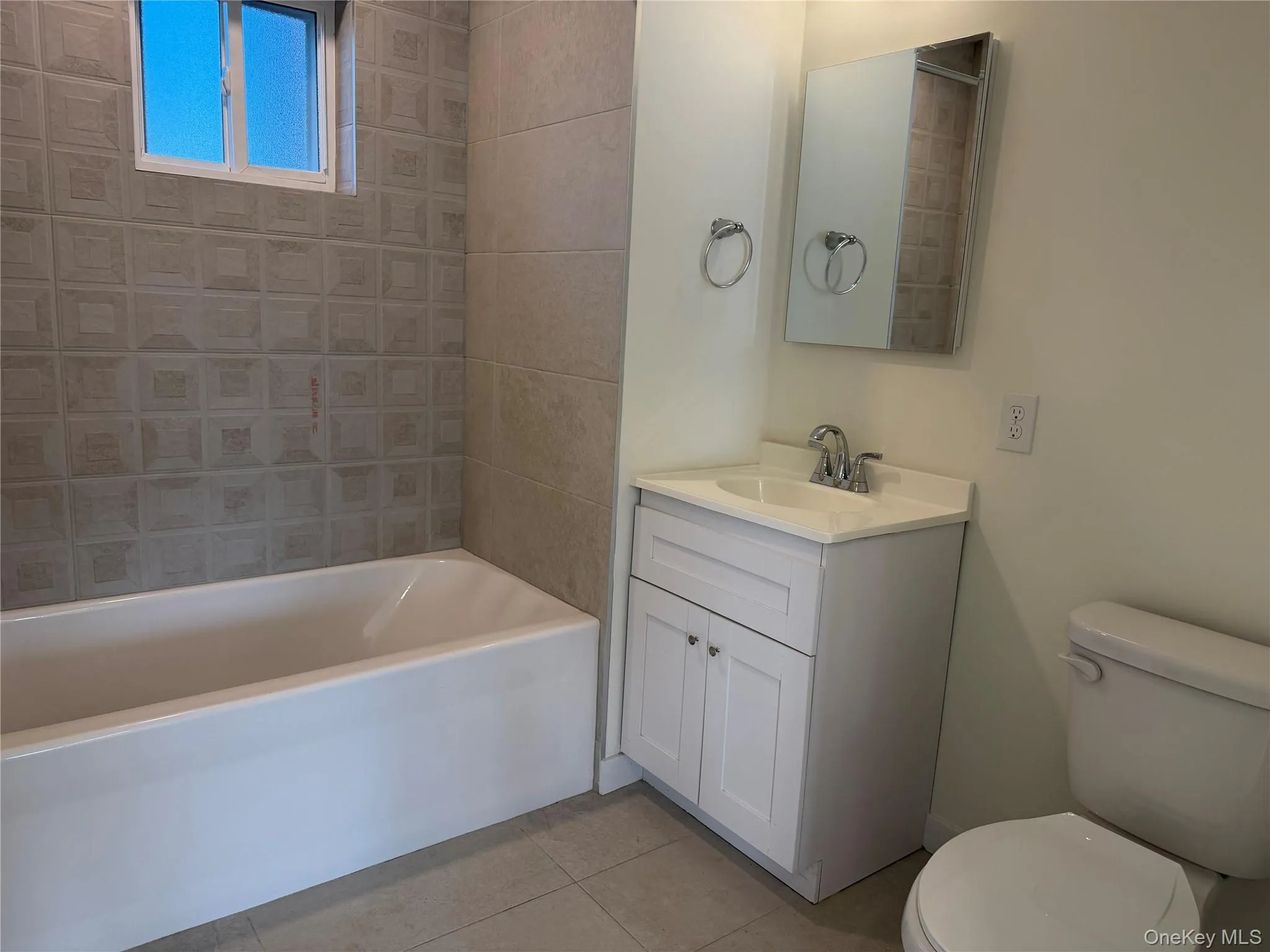 New Bathroom with tub, vanity and toilet with medicine cabinet. New Bathroom with tub, vanity and toilet with medicine cabinet.