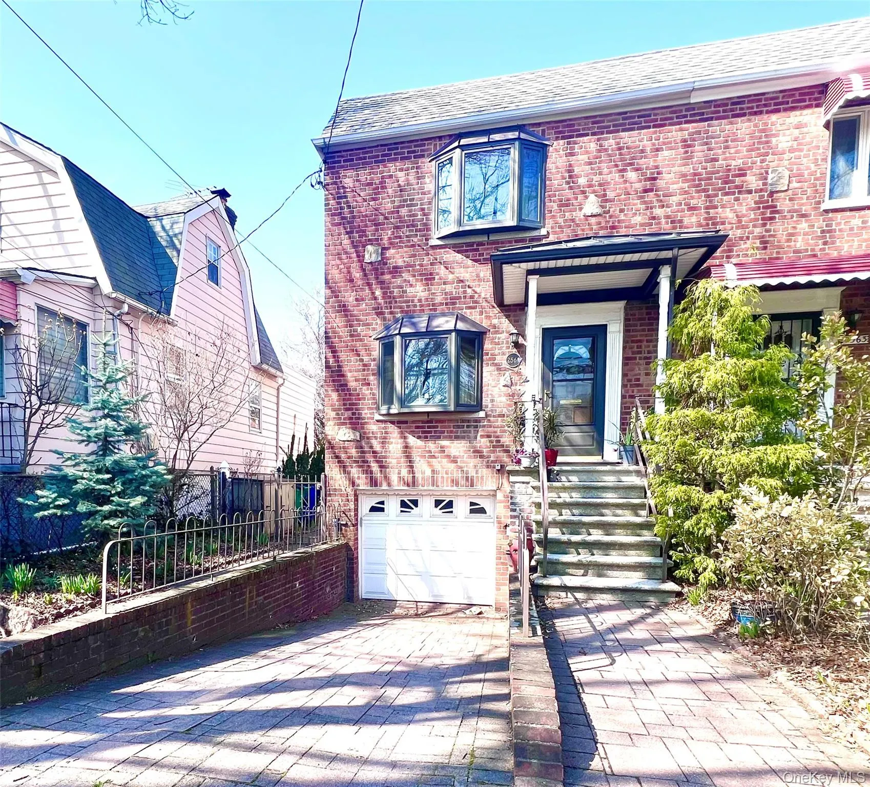 Brick semidetached comtemporary with bay windows and garage automatic door. Brick semidetached comtemporary with bay windows and garage automatic door.