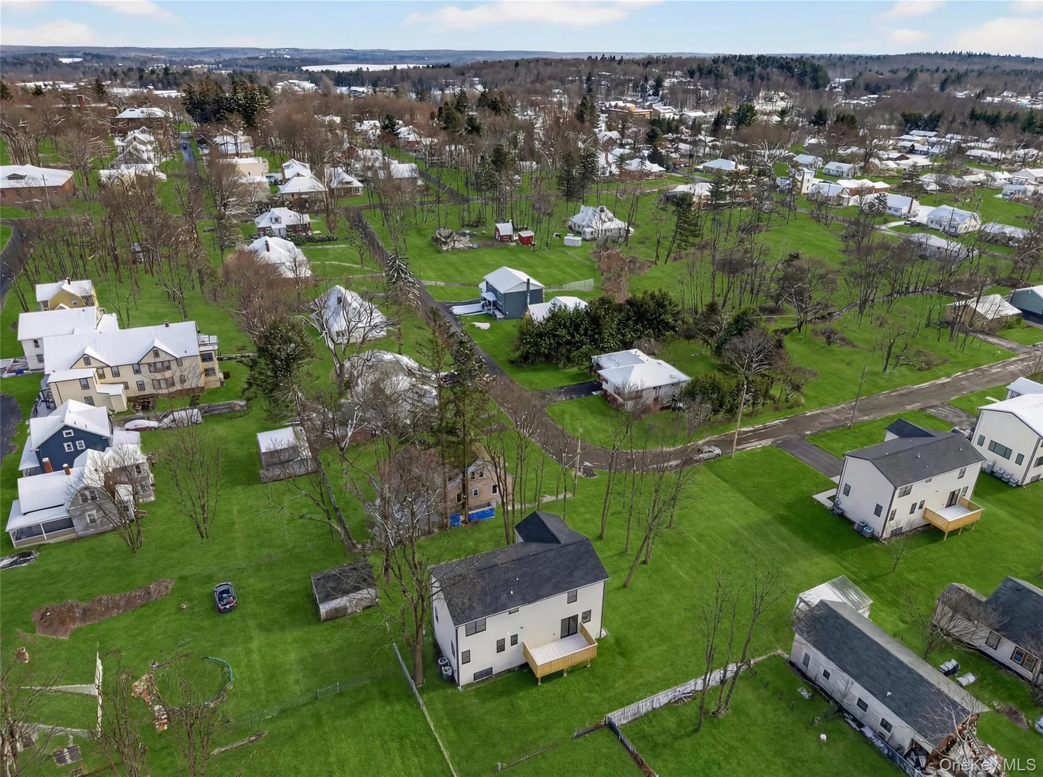 Aerial view of property and surrounding area featuring nearby suburban area Aerial view of property and surrounding area featuring nearby suburban area