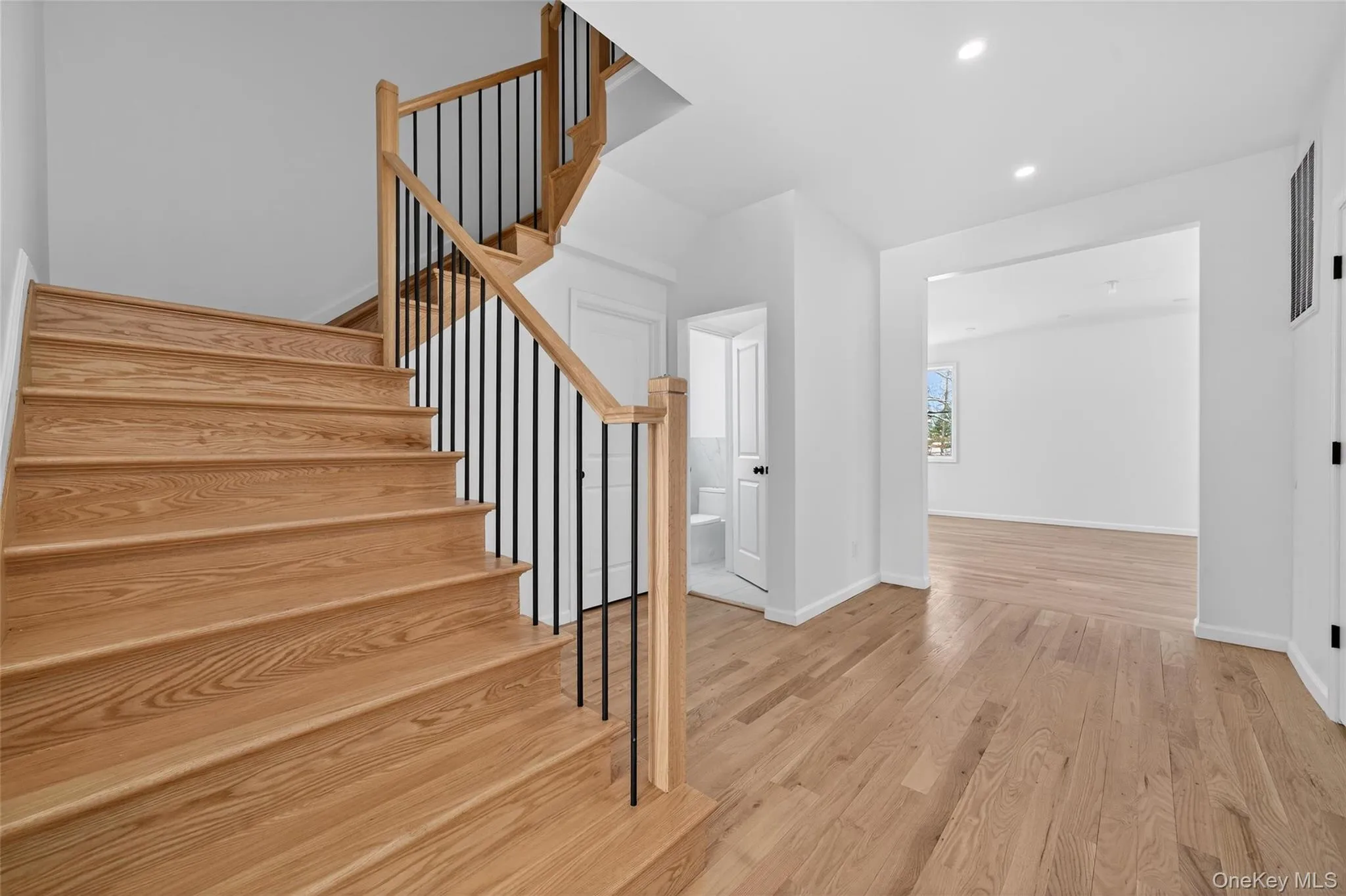 Staircase featuring wood finished floors and recessed lighting Staircase featuring wood finished floors and recessed lighting