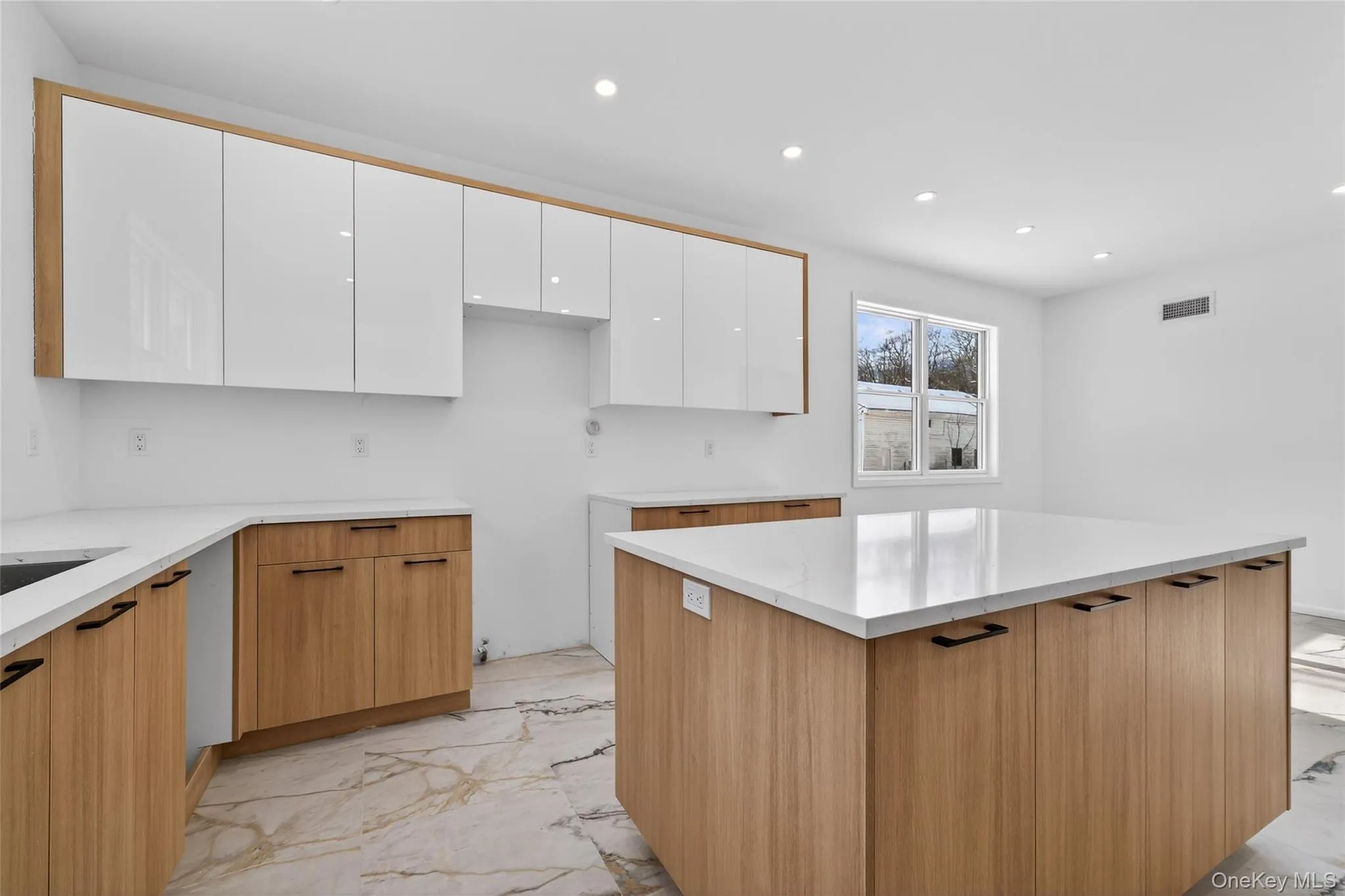 Kitchen featuring light marble finish flooring, white cabinets, recessed lighting, modern cabinets, and light stone countertops Kitchen featuring light marble finish flooring, white cabinets, recessed lighting, modern cabinets, and light stone countertops