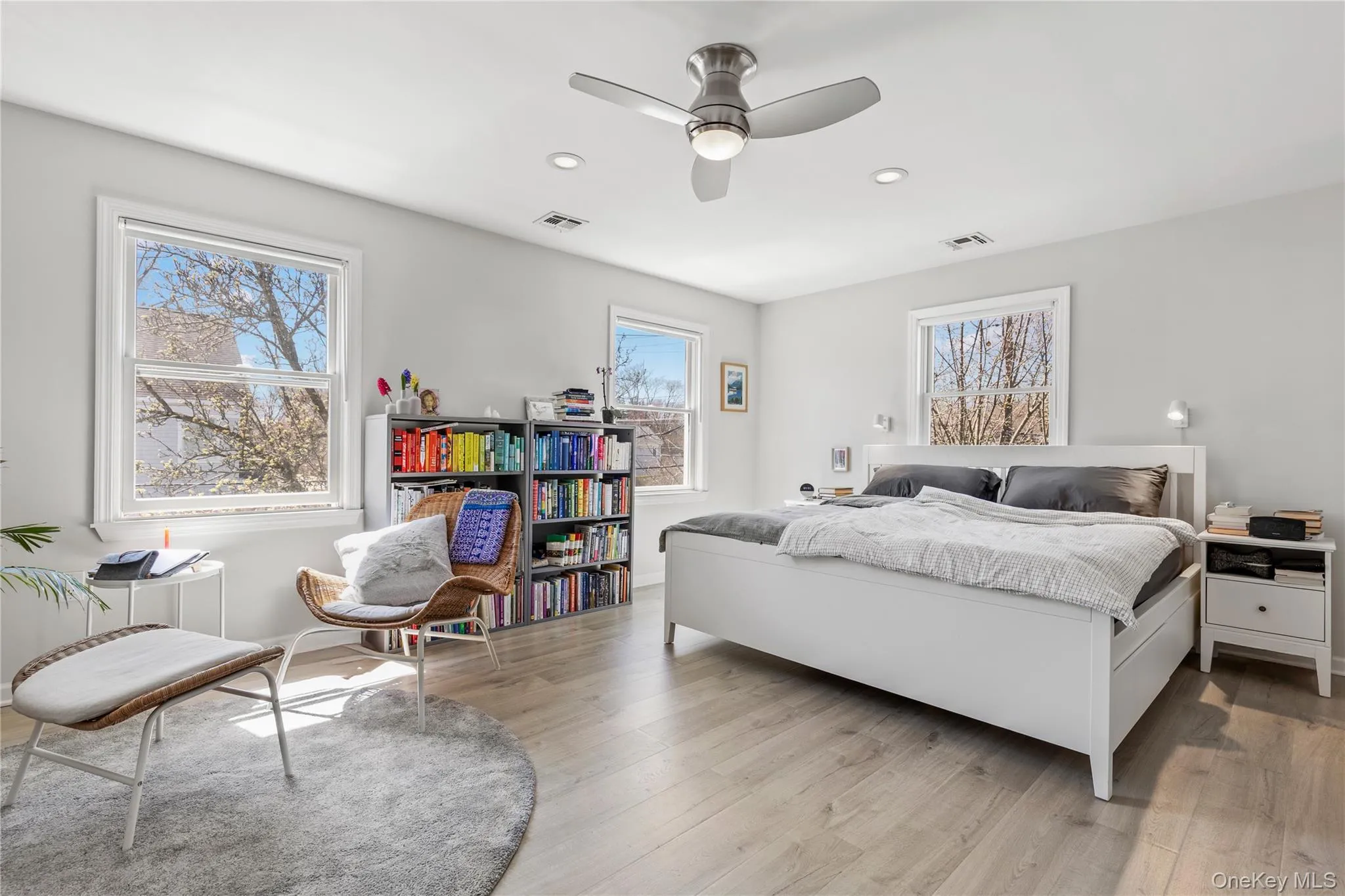 Oversized and bright primary bedroom enjoys a seating area for private enjoyment Oversized and bright primary bedroom enjoys a seating area for private enjoyment