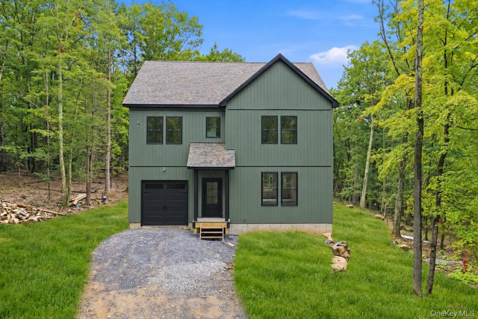 This photo has been digitally edited. Grass was added. Front door and garage door were changed to black to show what the home will look like once finished. This photo has been digitally edited. Grass was added. Front door and garage door were changed to black to show what the home will look like once finished.