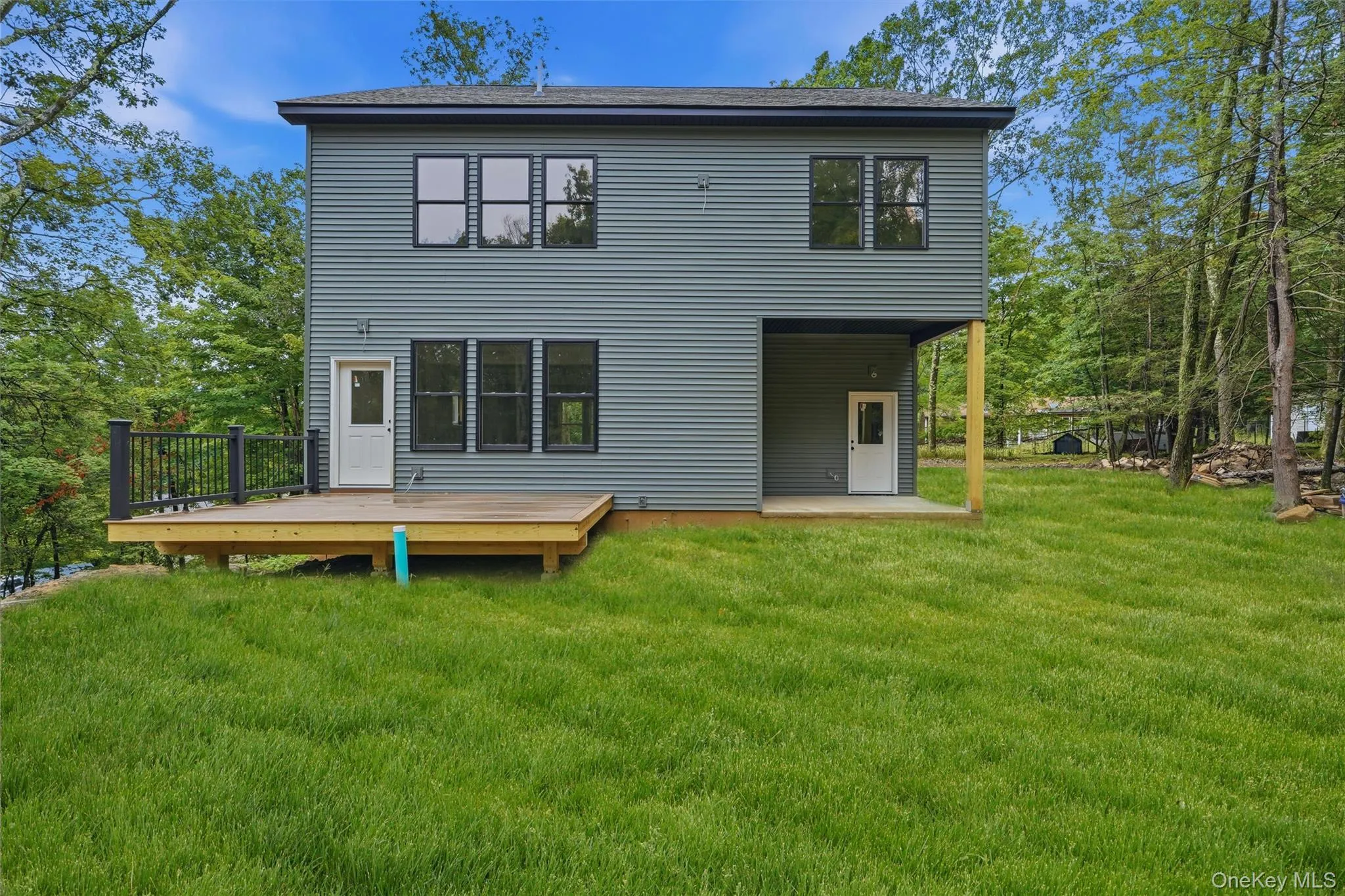 This photo has been digitally edited. Grass was added. Front door and garage door were changed to black to show what the home will look like once finished. This photo has been digitally edited. Grass was added. Front door and garage door were changed to black to show what the home will look like once finished.