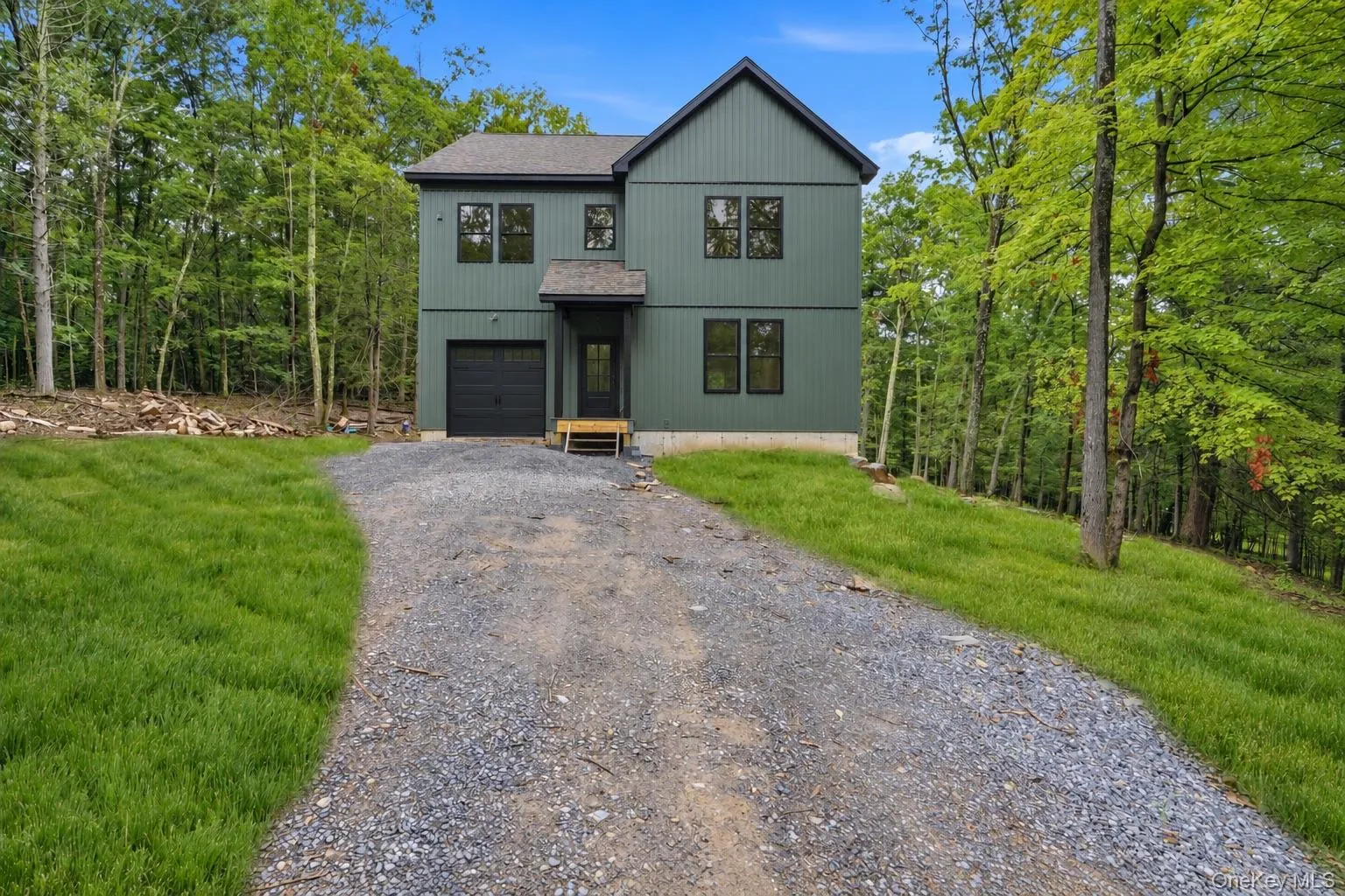 This photo has been digitally edited. Grass was added. Front door and garage door were changed to black to show what the home will look like once finished. This photo has been digitally edited. Grass was added. Front door and garage door were changed to black to show what the home will look like once finished.