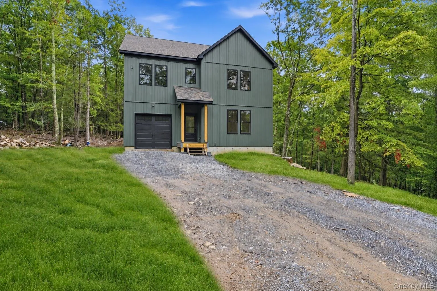 This photo has been digitally edited. Grass was added. Front door and garage door were changed to black to show what the home will look like once finished. This photo has been digitally edited. Grass was added. Front door and garage door were changed to black to show what the home will look like once finished.