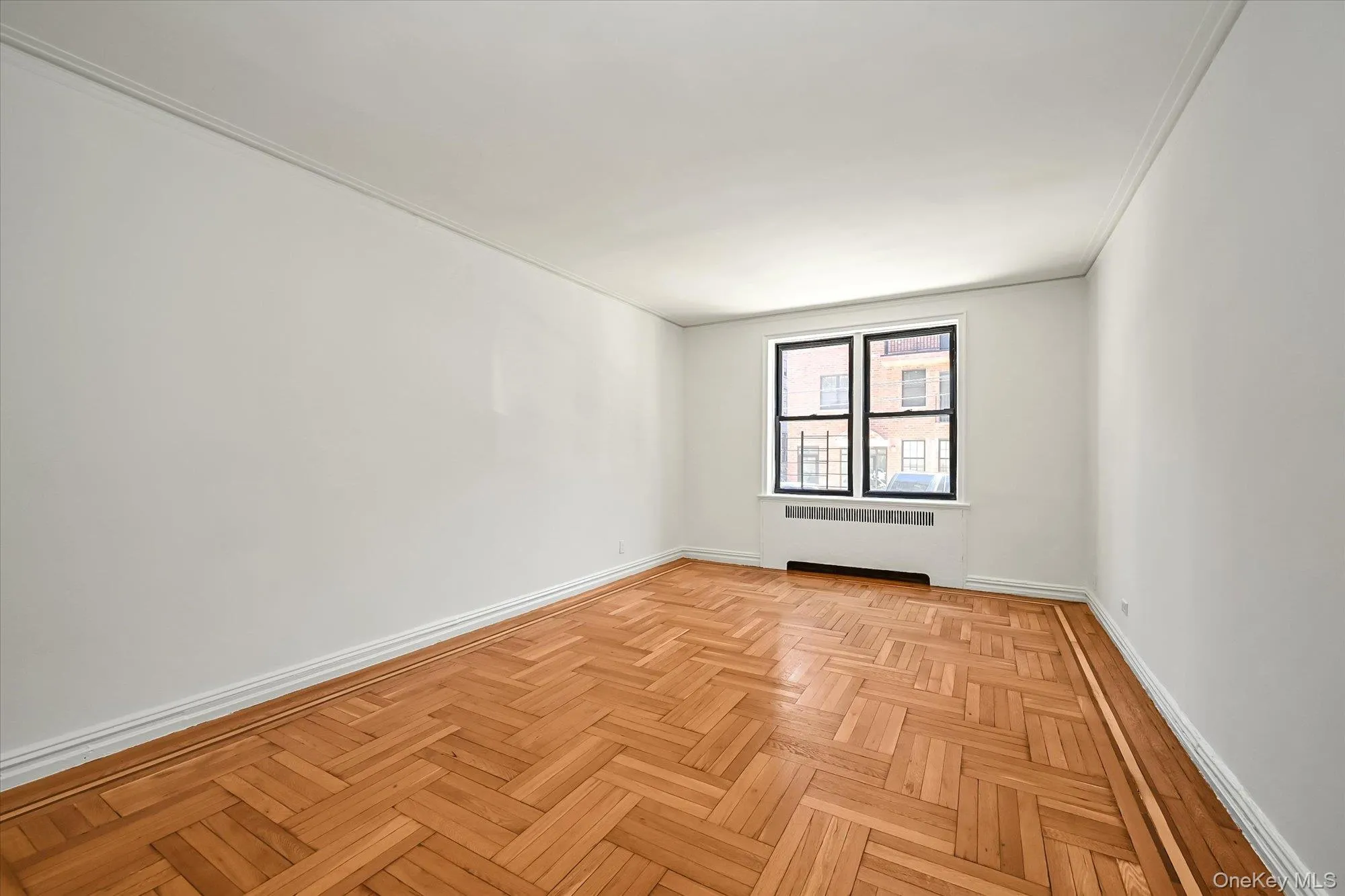 Room with radiator and parquet flooring Room with radiator and parquet flooring