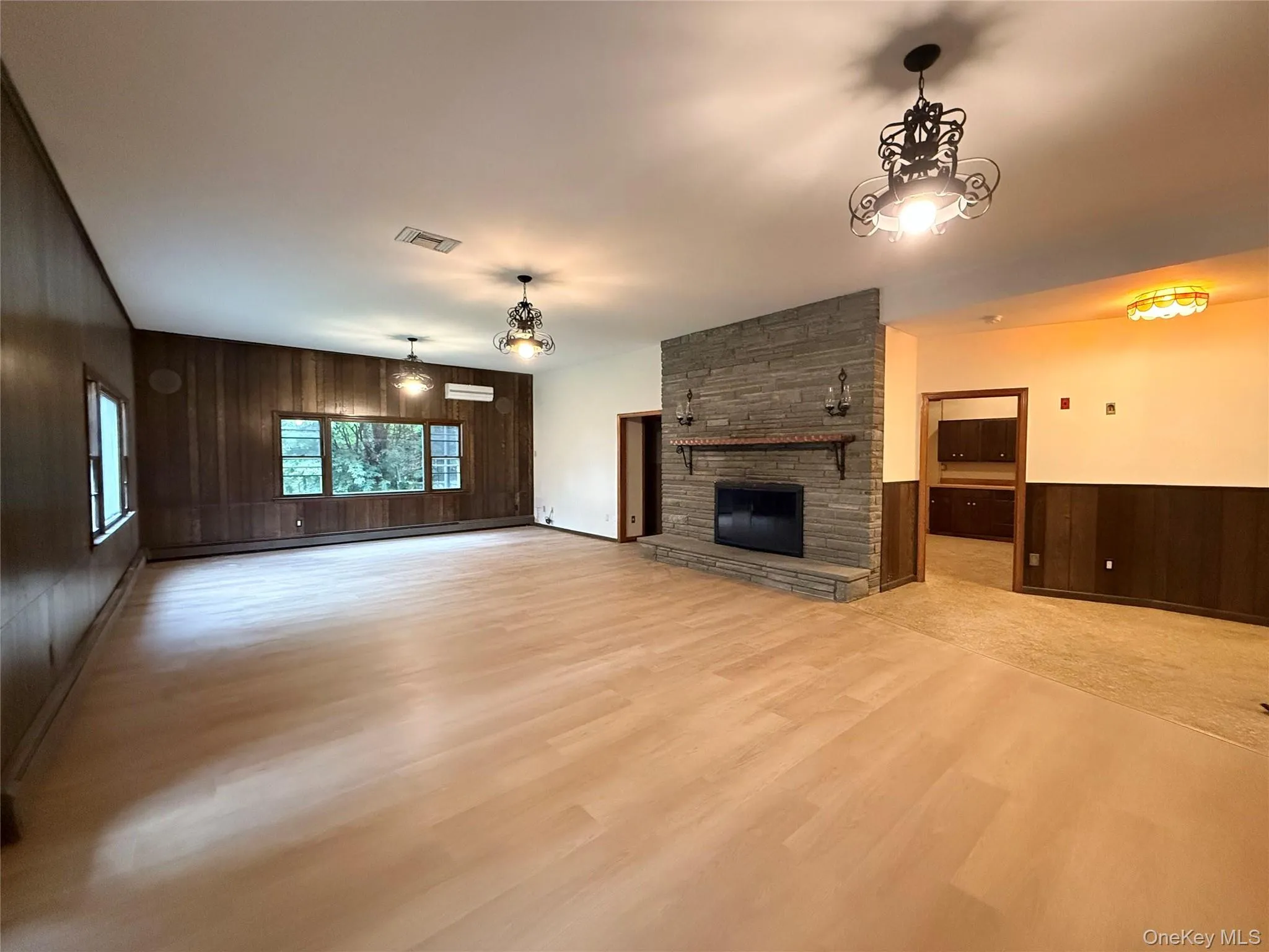 Family room w/ wood burning fireplace with updated flooring. Family room w/ wood burning fireplace with updated flooring.