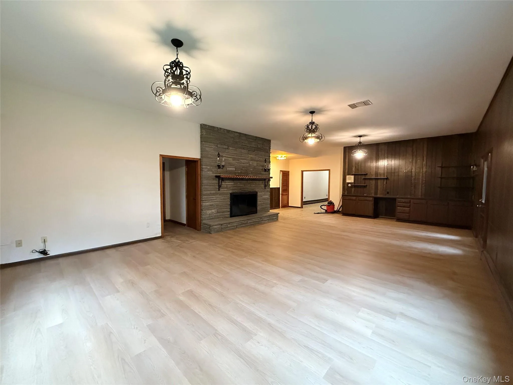 Family room w/ wood burning fireplace with updated flooring. Family room w/ wood burning fireplace with updated flooring.